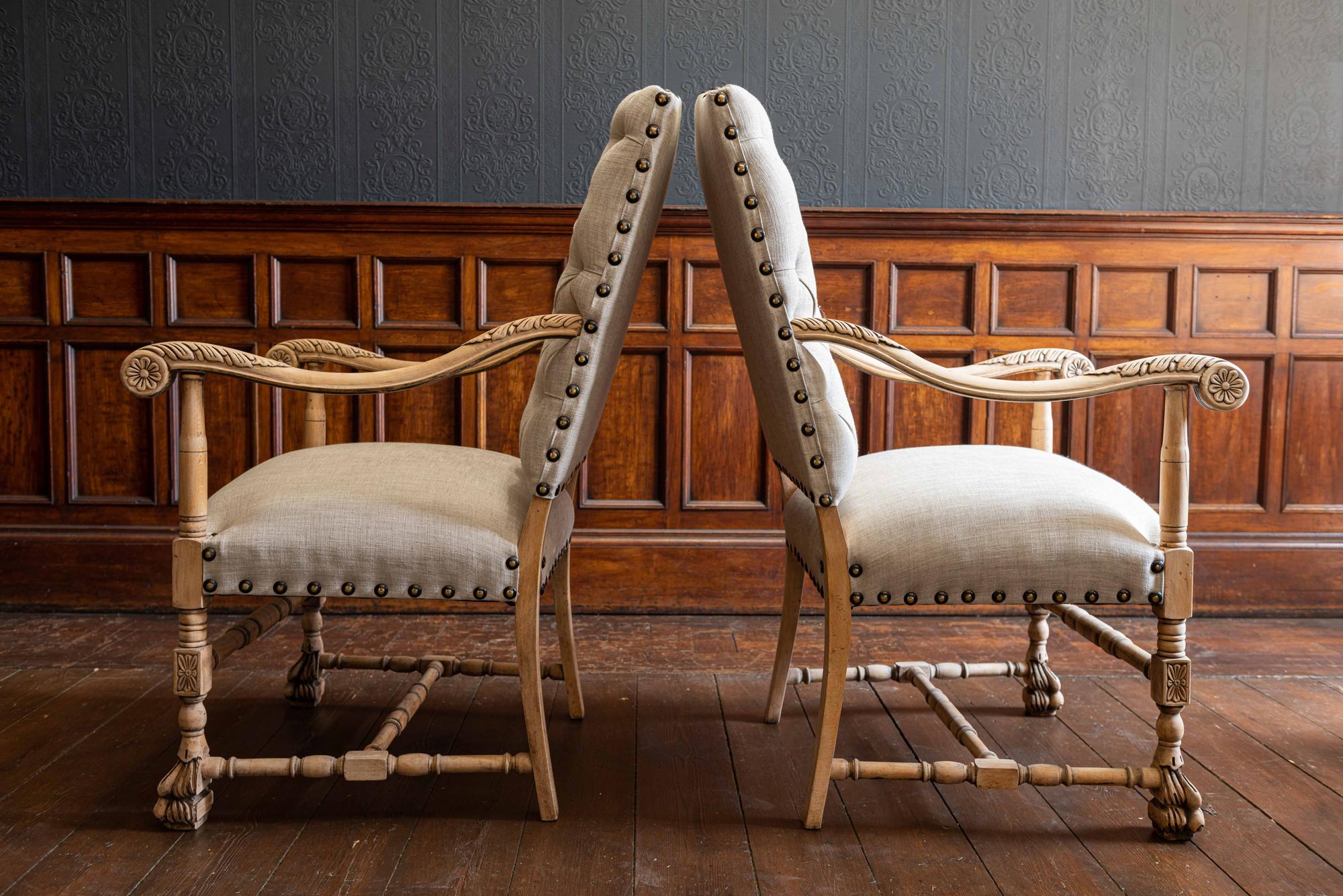Pair of 19th century French library armchairs reupholstered in linen,
circa 1890.

Bleached beech carved frames sat upon large lion paw feet. Upholstered in neutral linen and finished with large brass studs.

Price is for the pair.

Measures: 120 H