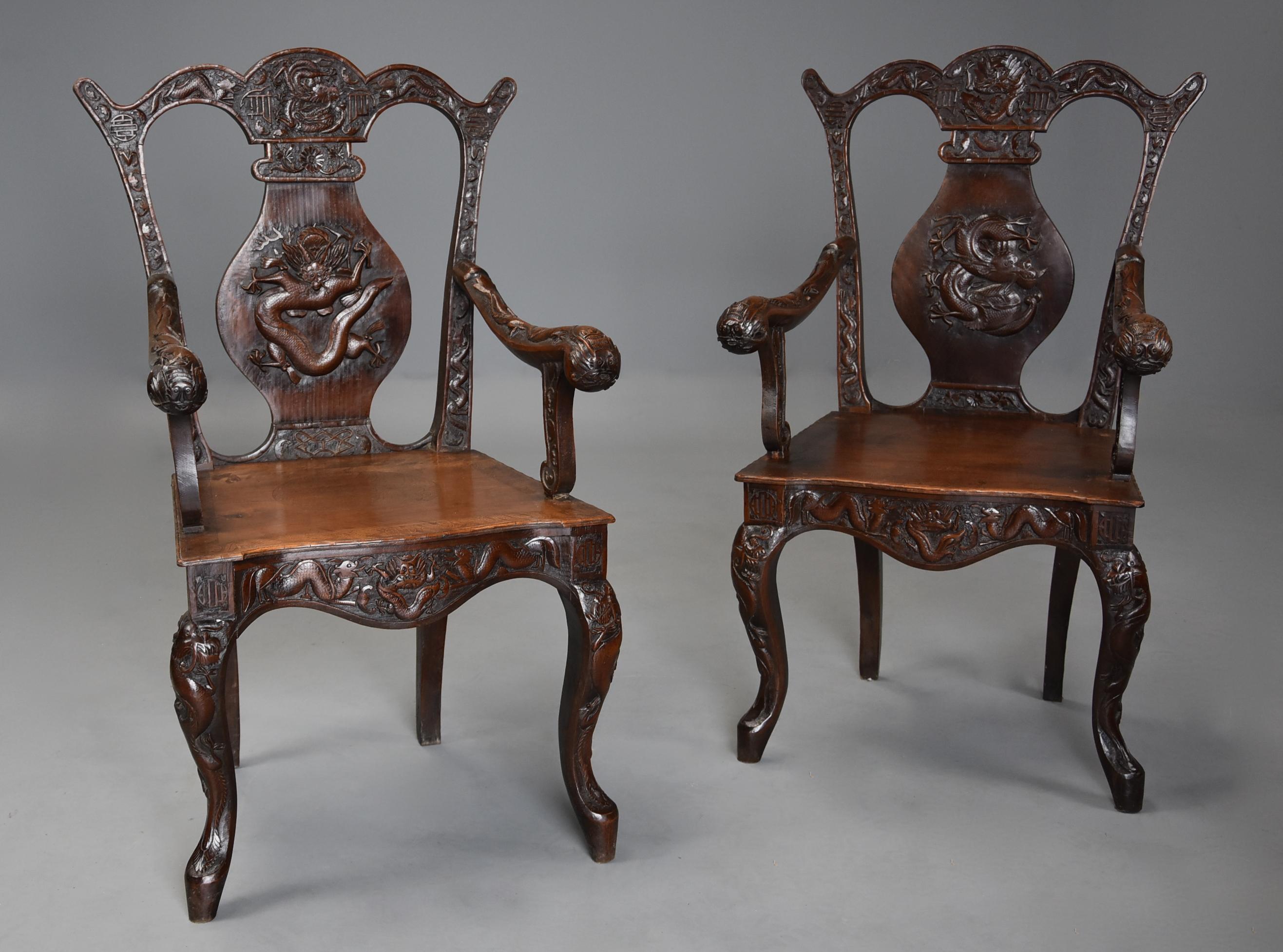 A pair of 19th century profusely carved walnut open armchairs of Chinese influence in the 18th century style, possibly French.

This highly decorative pair of chairs consist of a shaped top rail with dragon, Chinese symbol, bat and floral carved