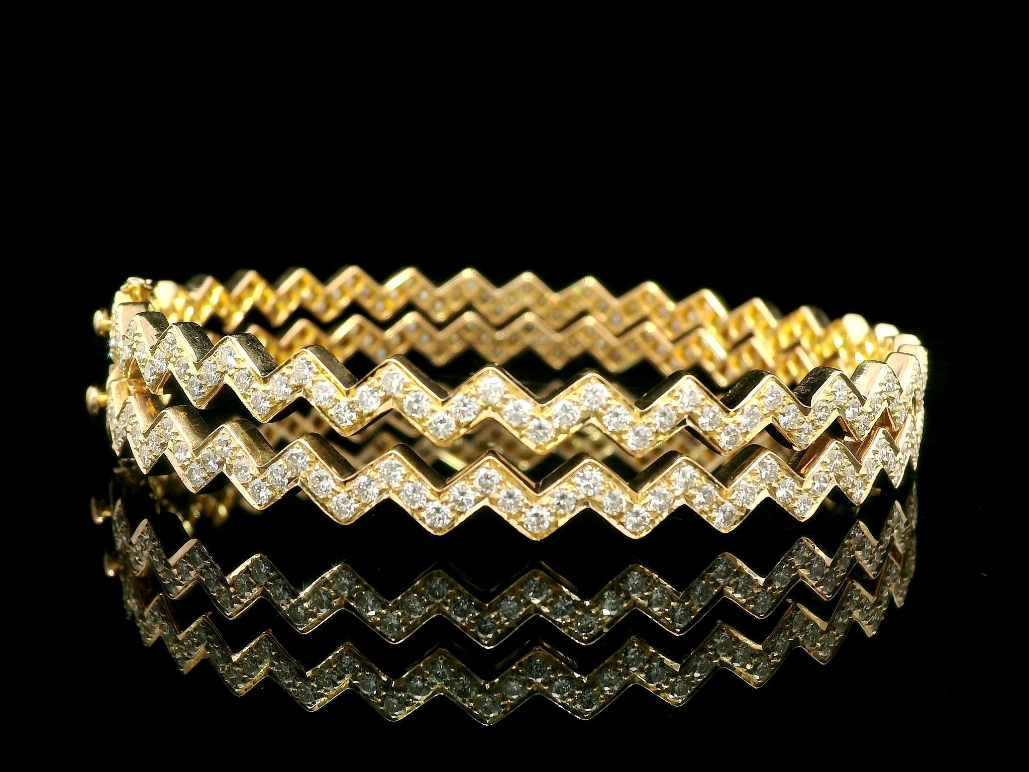 --Stones:--
250 Natural Genuine Diamonds - Round Brilliant Cut - Pave Set - F/G Color - VS1/VS2 Clarity - 4.61ctw exact

Material: Solid 18K Yellow Gold
Weight: 29.73 Grams (weight of the pair)
Type: Pair of 2 Hinged Bangle Bracelets
Inner Diameter: