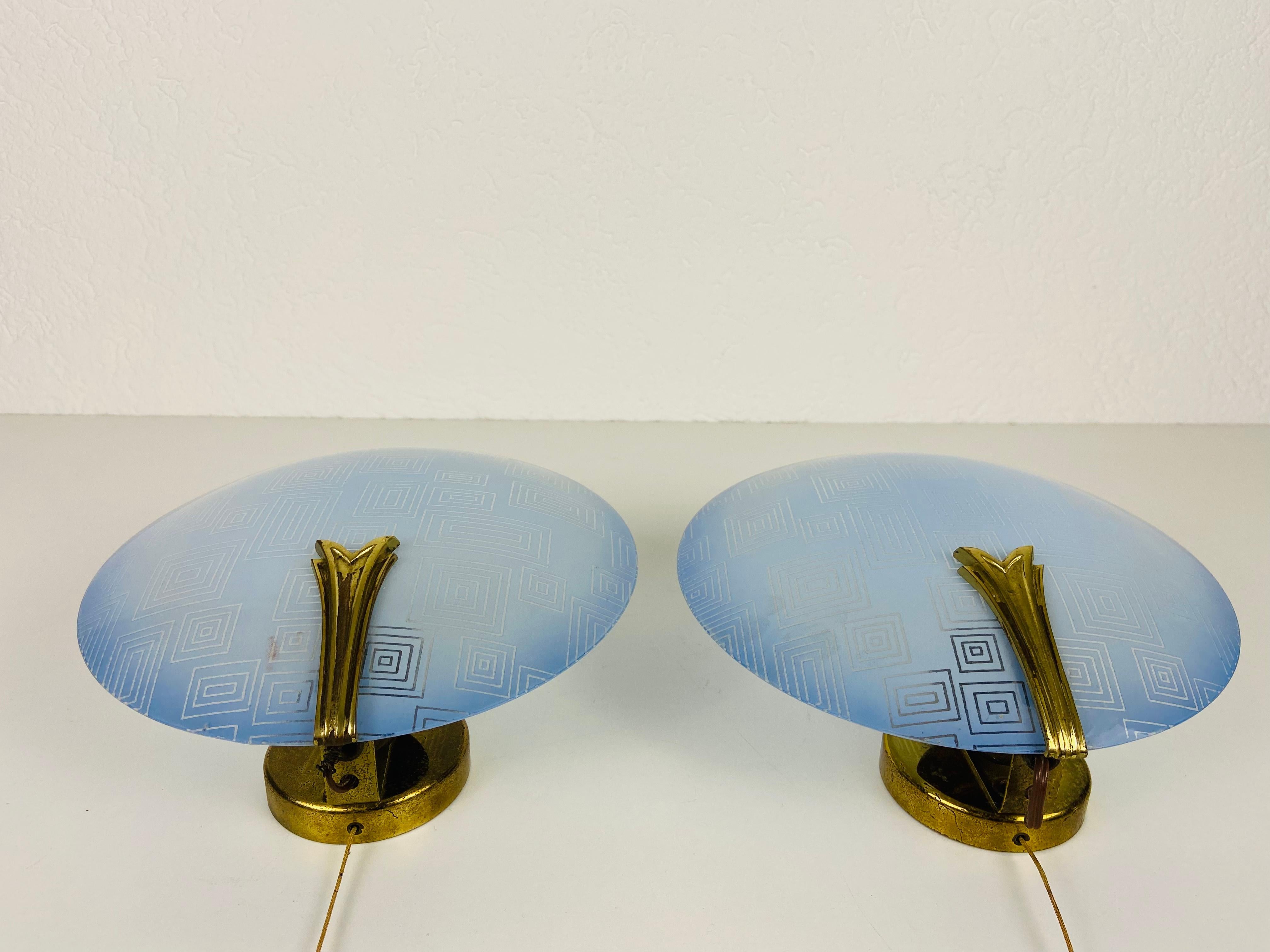 Brass and blue glass sconces made in Germany in the 1960s. The lamps are in a very good condition.

The lights require E14 light bulbs. Works with both 120/220V. 

Free worldwide shipping.