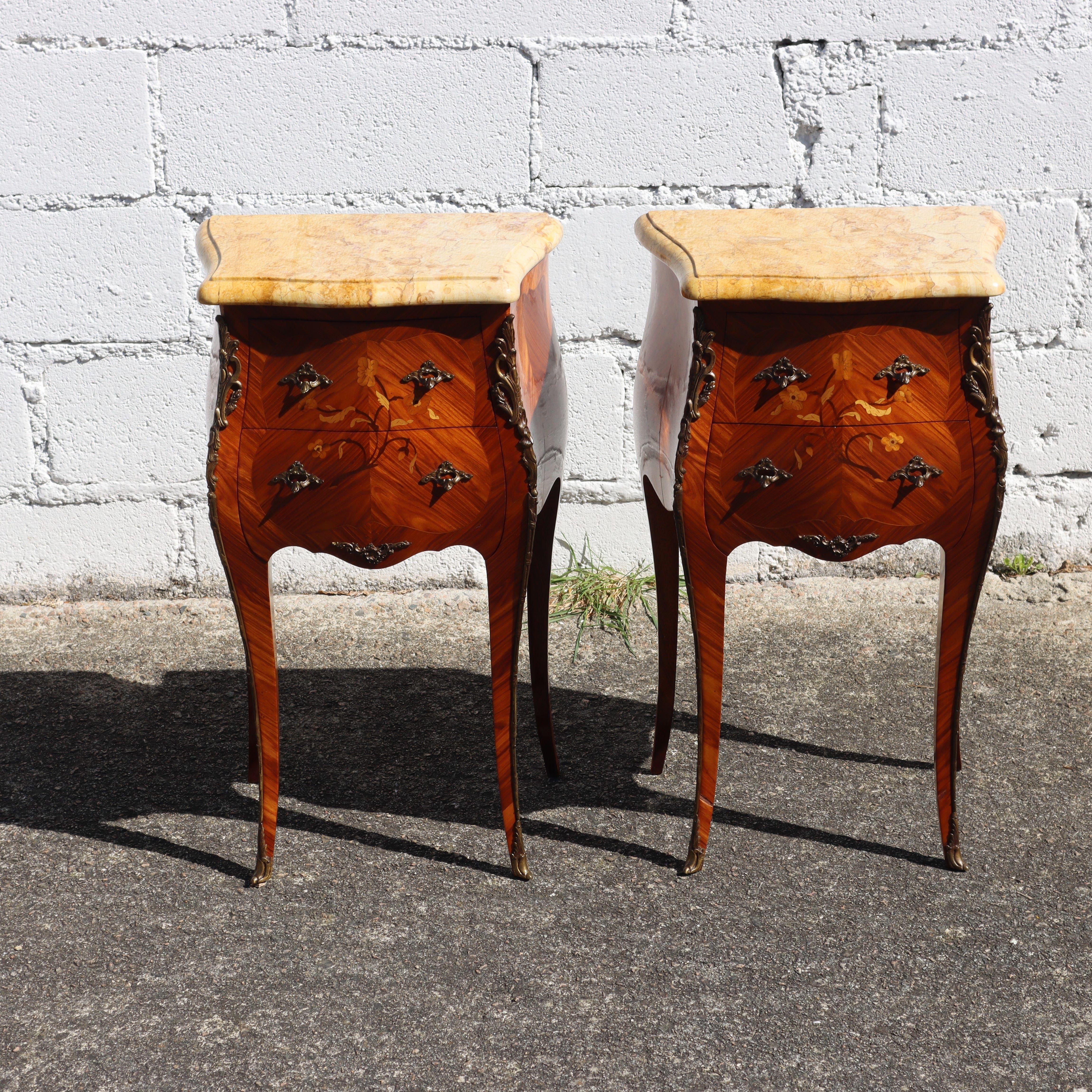 Pair of 2 Vintage French Louis XV Rosewood Marquetry Marble Top Nightstands from the 50s
Cabinet Maker Masterpiece - Wonderful Rosewood Marquetry with floral Inlay Work.
Equipped with 2 Drawers decorated with Brass Handles with ormolu