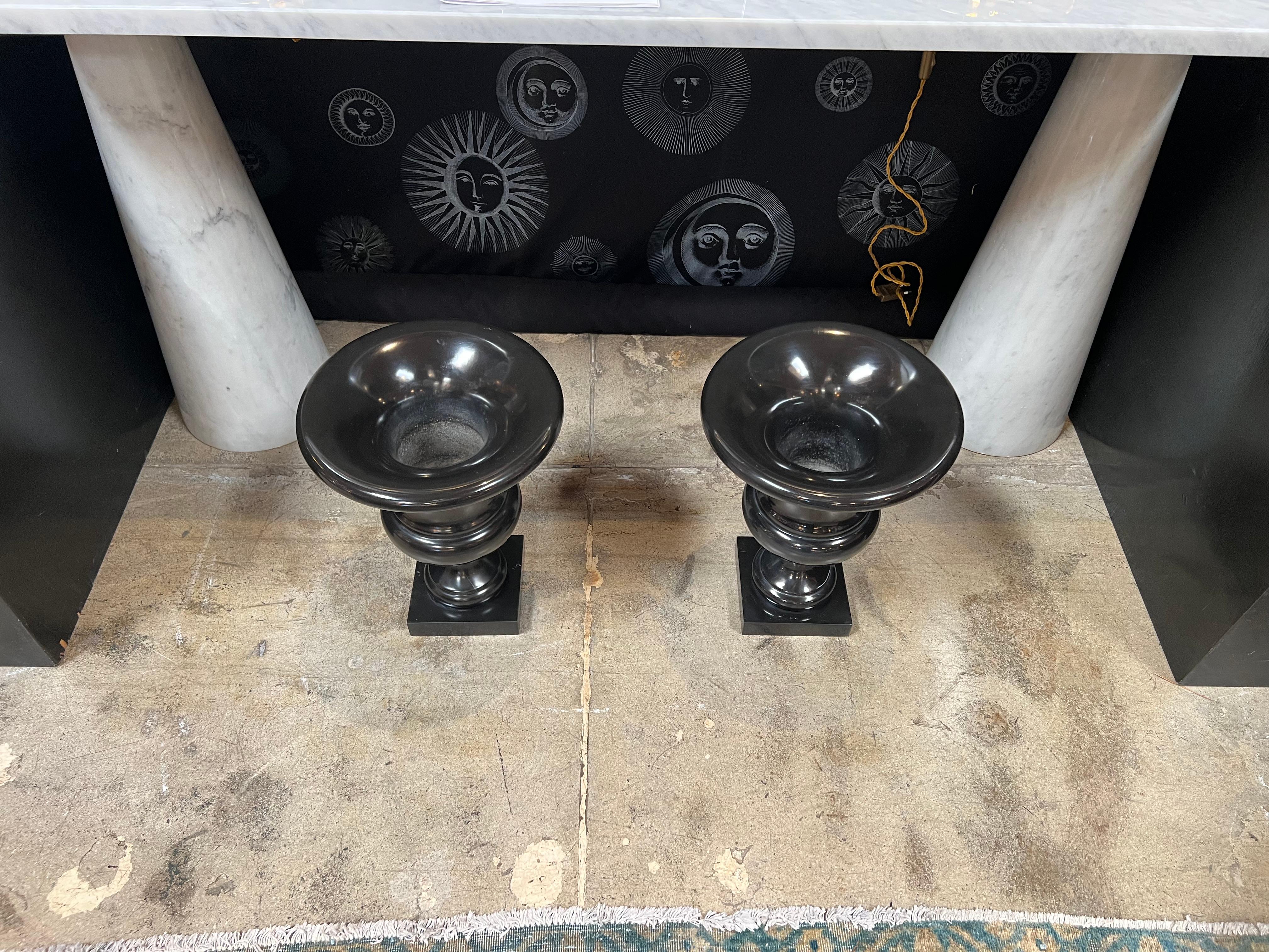The Pair of 2 Italian Decorative Black Vases from the 1960s is a set of elegant vases with a sleek black finish, originating from Italy. These vases showcase the artistic flair of the era, combining form and function to enhance interior spaces with