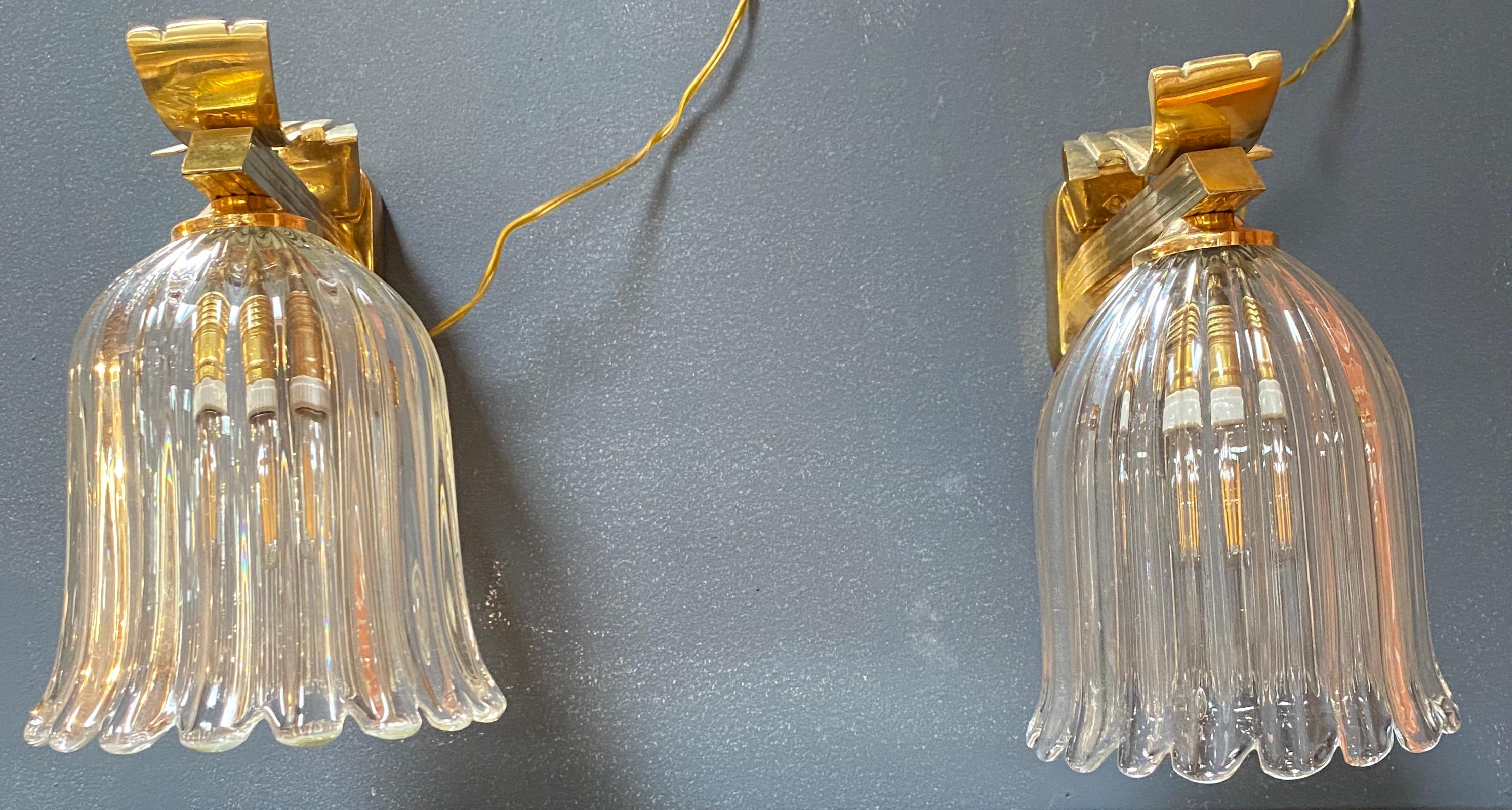 Beautiful and exclusive pair of two wall sconces made in Italy with brass and glass in 1970.