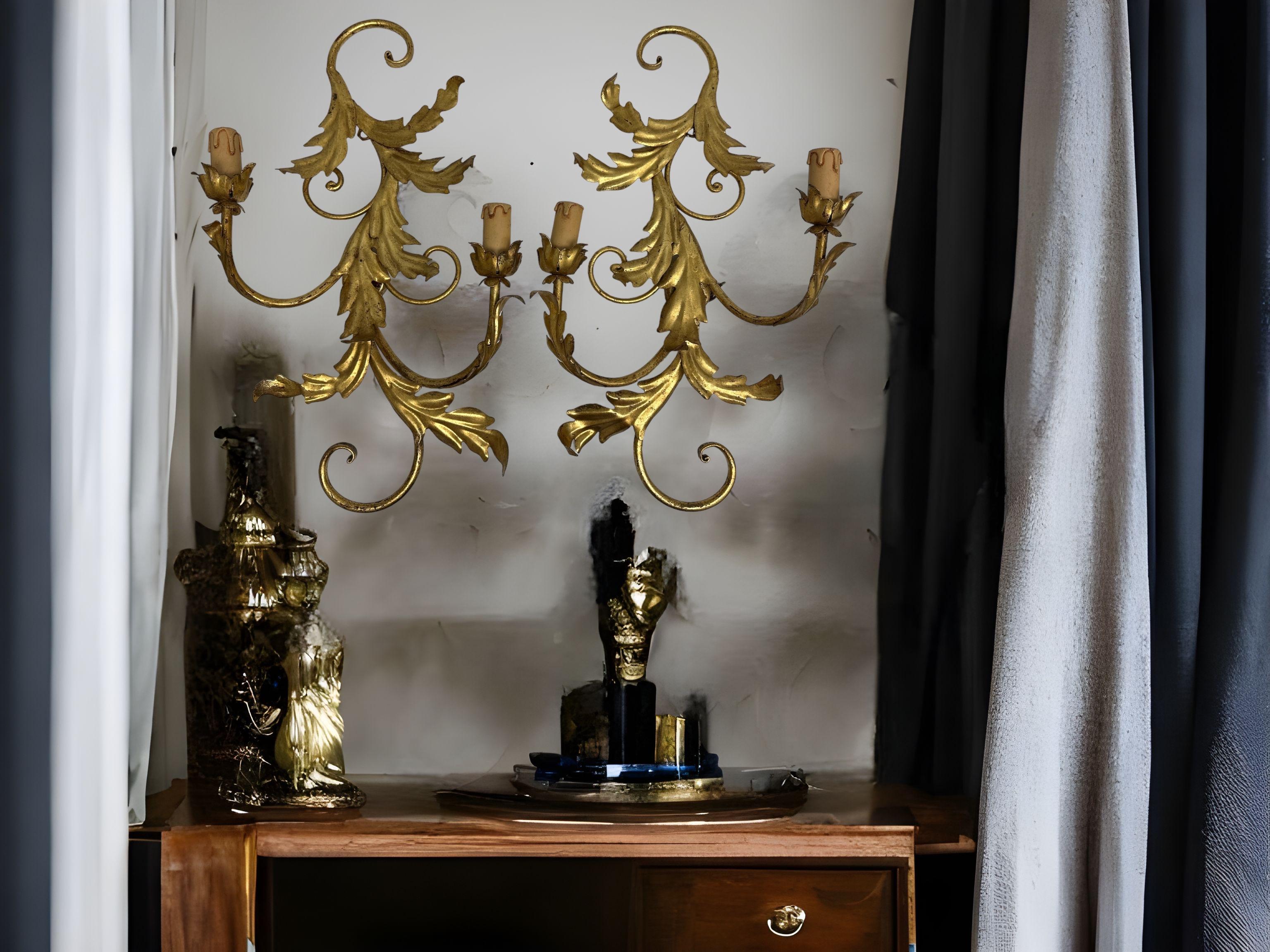 A pair Hollywood Regency midcentury gilt leaf tole sconces, each fixture requires two European E14 candelabra bulbs, each up to 40 watts. The wall lights have a beautiful patina and give each room a eclectic statement. Made by Koegel Kogl Leuchten
