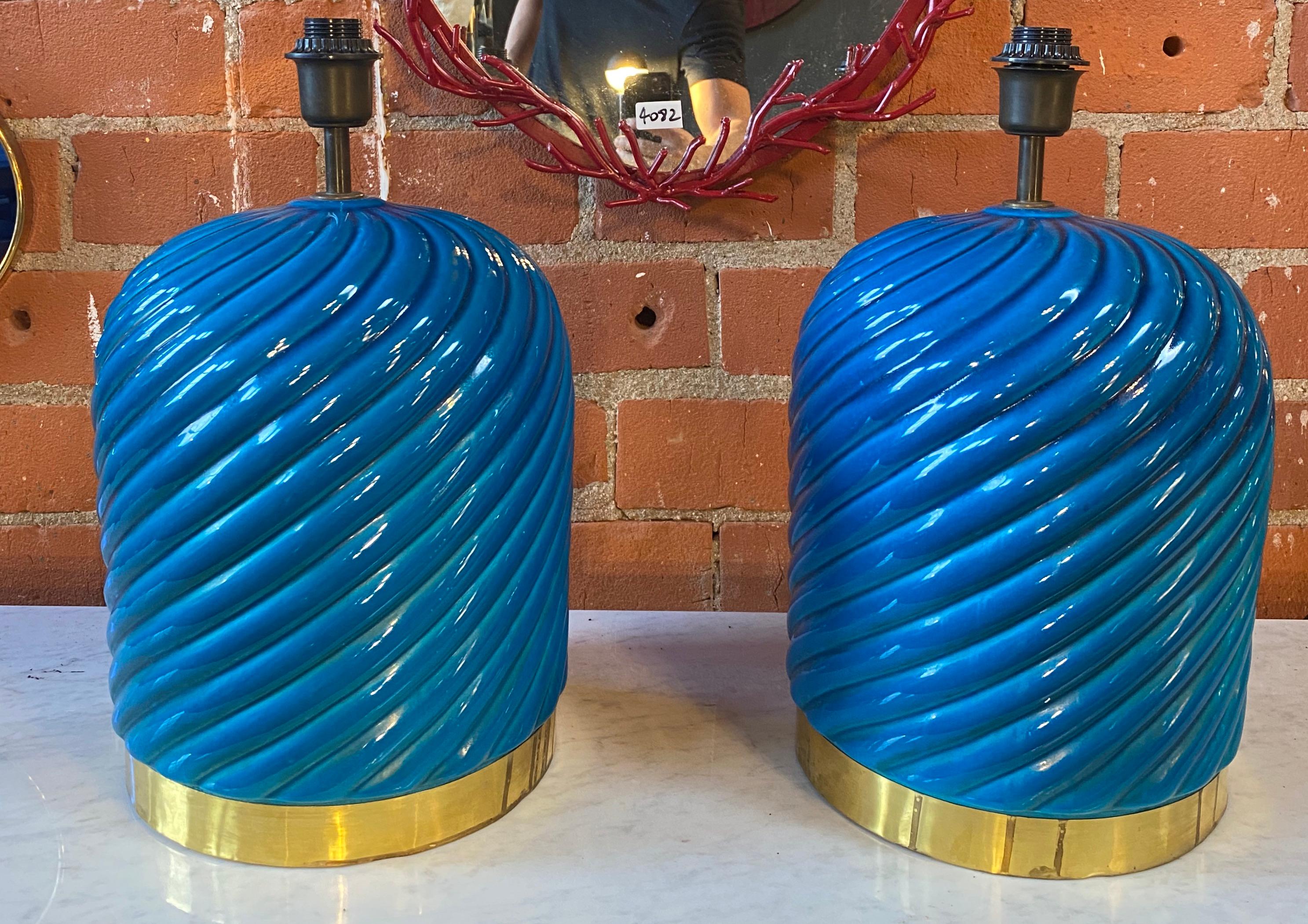 Pair of 2 table lamps made with blue ceramic and brass details. The lamps do not include shades.