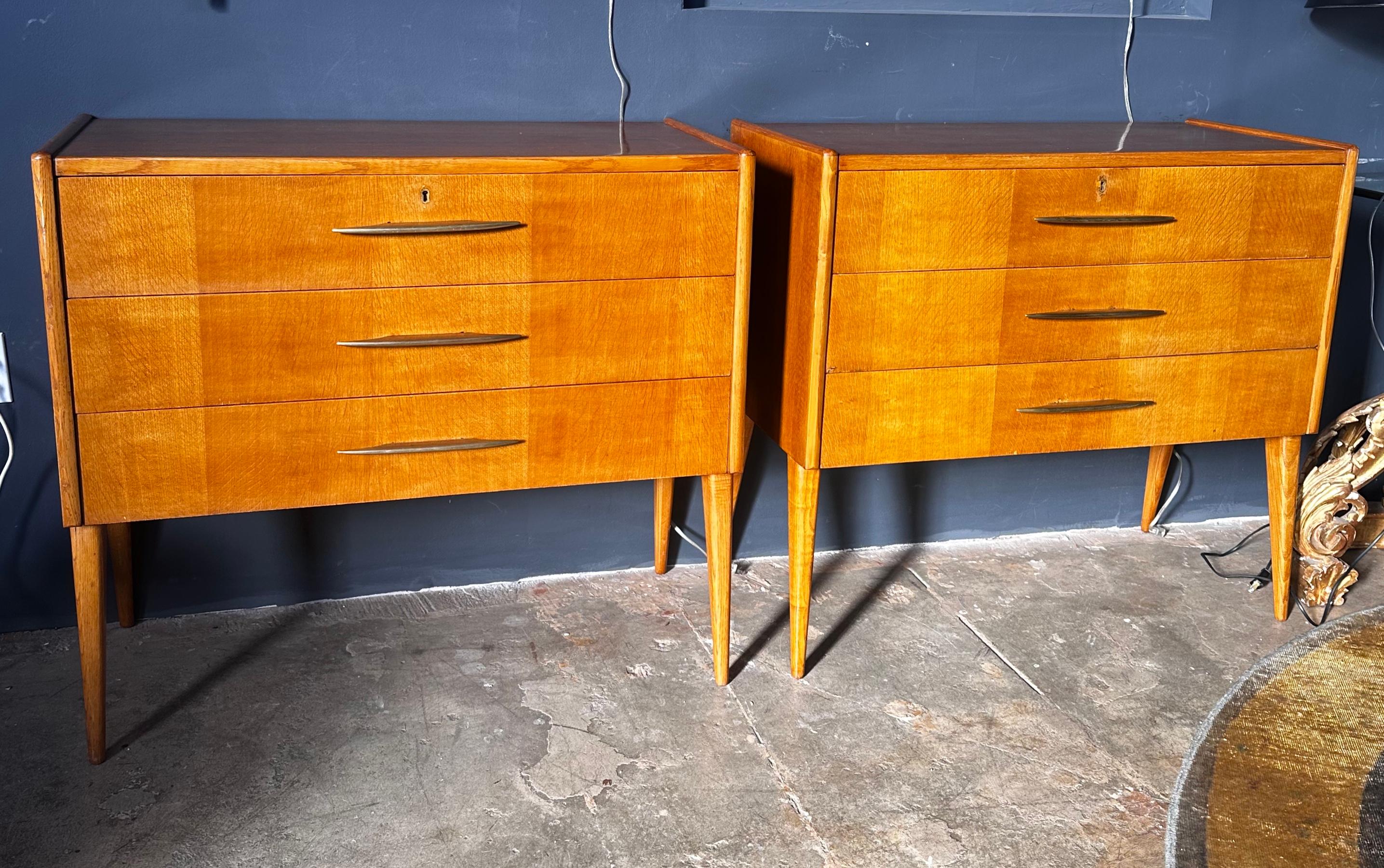 Elevate your space with this exquisite pair of Mid-Century Italian Credenzas. Crafted in the 1970s, each credenza features three drawers adorned with sleek brass handles. The perfect blend of form and function, these pieces bring vintage charm to