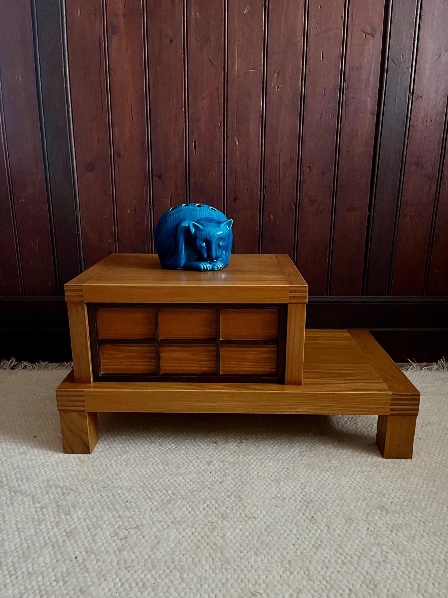 Unusual pair of elmwood night stands .
Two tier,  with a drawer in the higher part decorated with stained elmwood motive in 