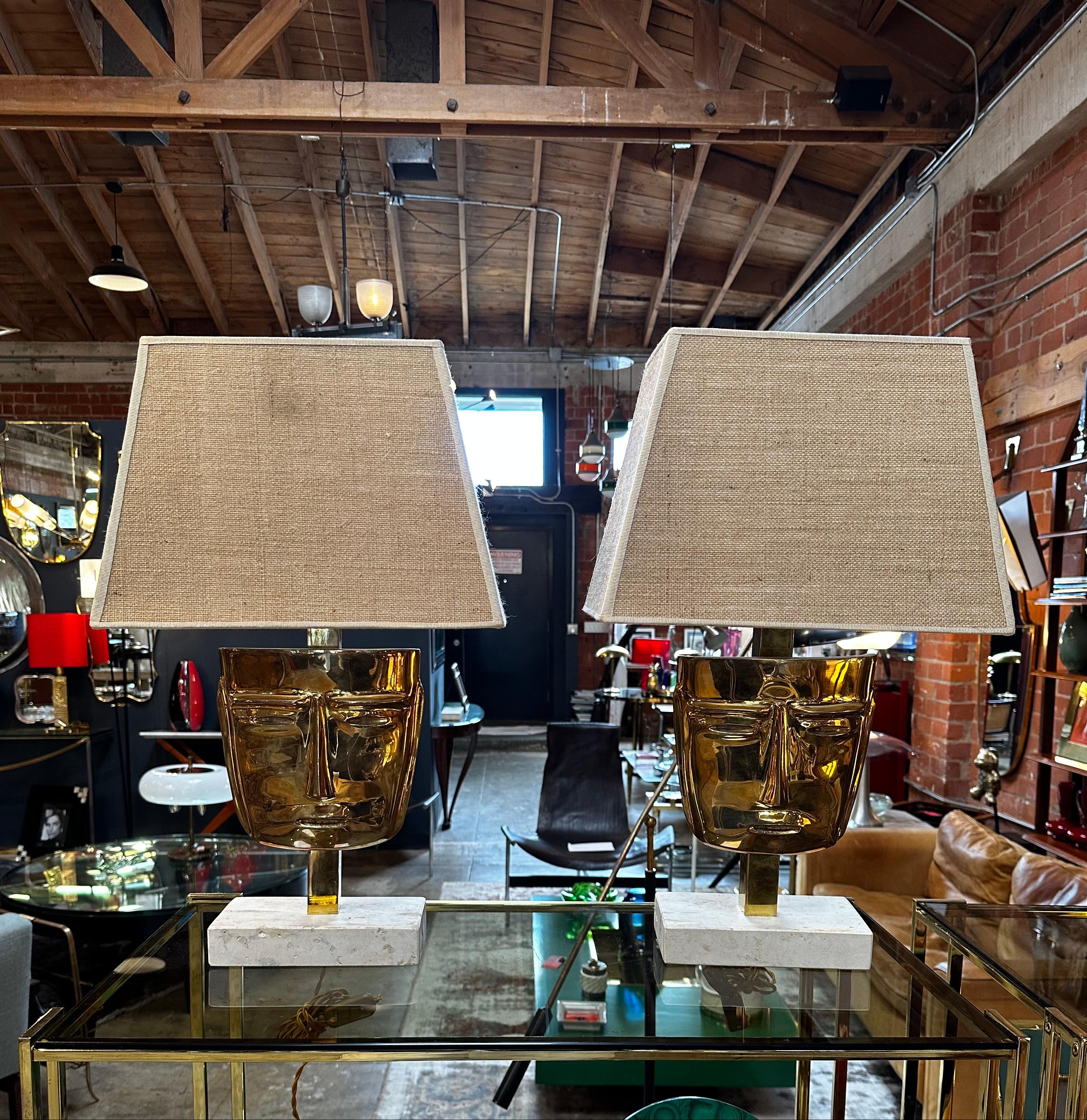 A pair of Italian table lamps made in Italy featuring a marble base and brass face with original shades would be a luxurious and elegant addition to any space. The marble base would likely feature a smooth and polished surface, with natural