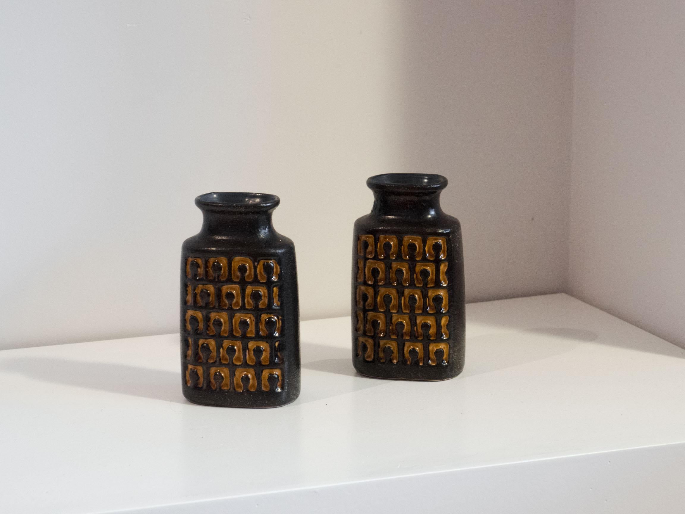 Set of two identical vases from West-Germany, 1960s.

This set of ceramic vases was made by VEB Haldensleben and they have a black and yellow glazing with a very interesting motif on both sides.

The pair is in excellent condition.