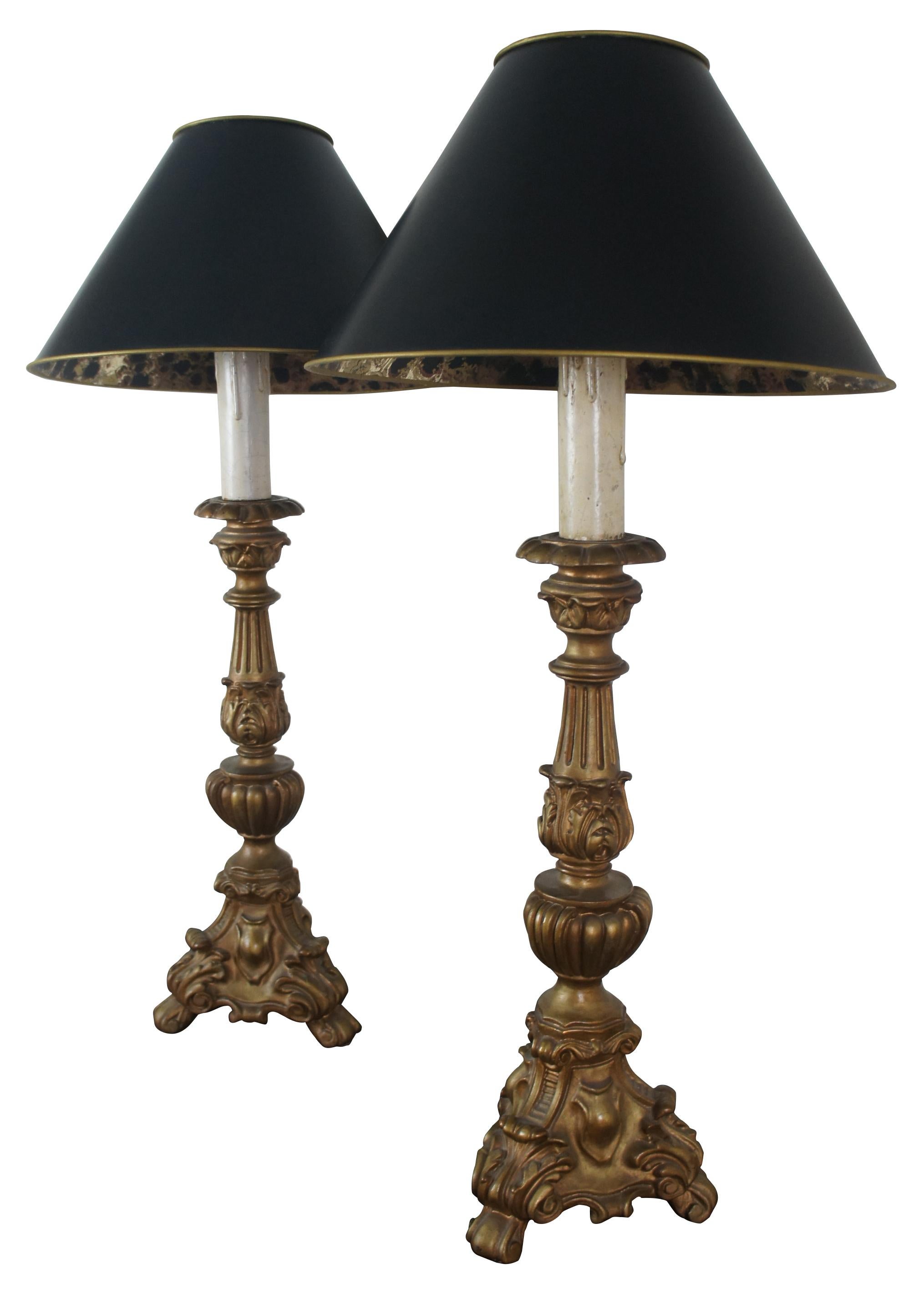 Pair of tall composite candlestick or alter shaped lamps with bronze finish, and black shades with foiled interiors.

Measures: 9” x 31.5”, shade 17” x 9” (diameter x height).