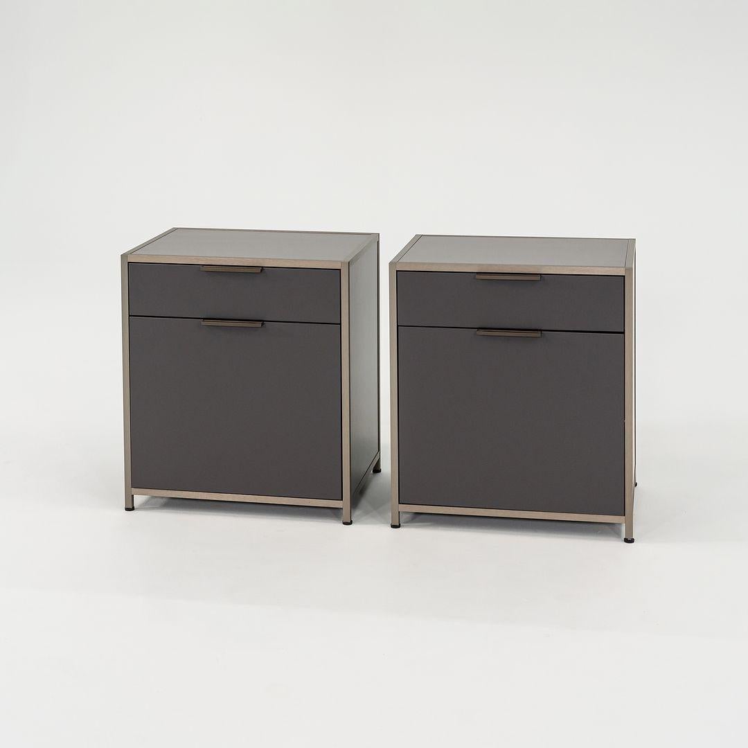 Listed for sale is a pair of medium Dita nightstands with 1 drawer and 1 door. One door opens left and the other opens right. The chest is made of grey lacquered wood panels and an anodized aluminum frame. The chests were designed by Pagnon and