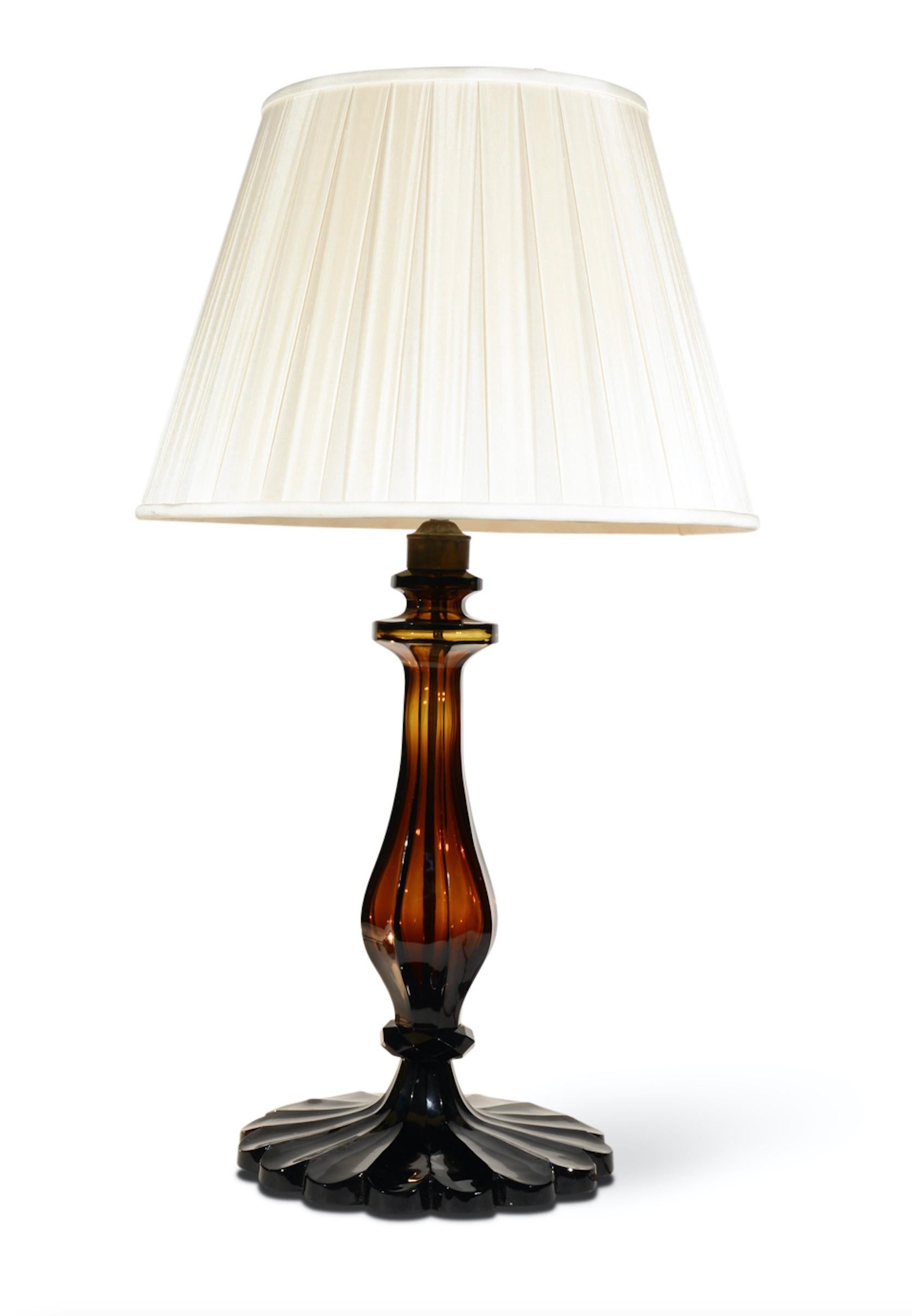 A superb pair of amber cut-glass table lamps, each with moulded faceted baluster stems, and scalloped base.

Measures: Height 19 in (48.5 cm) excluding electrical fitments and lampshades.

All of our lamps can be wired for use worldwide. A
