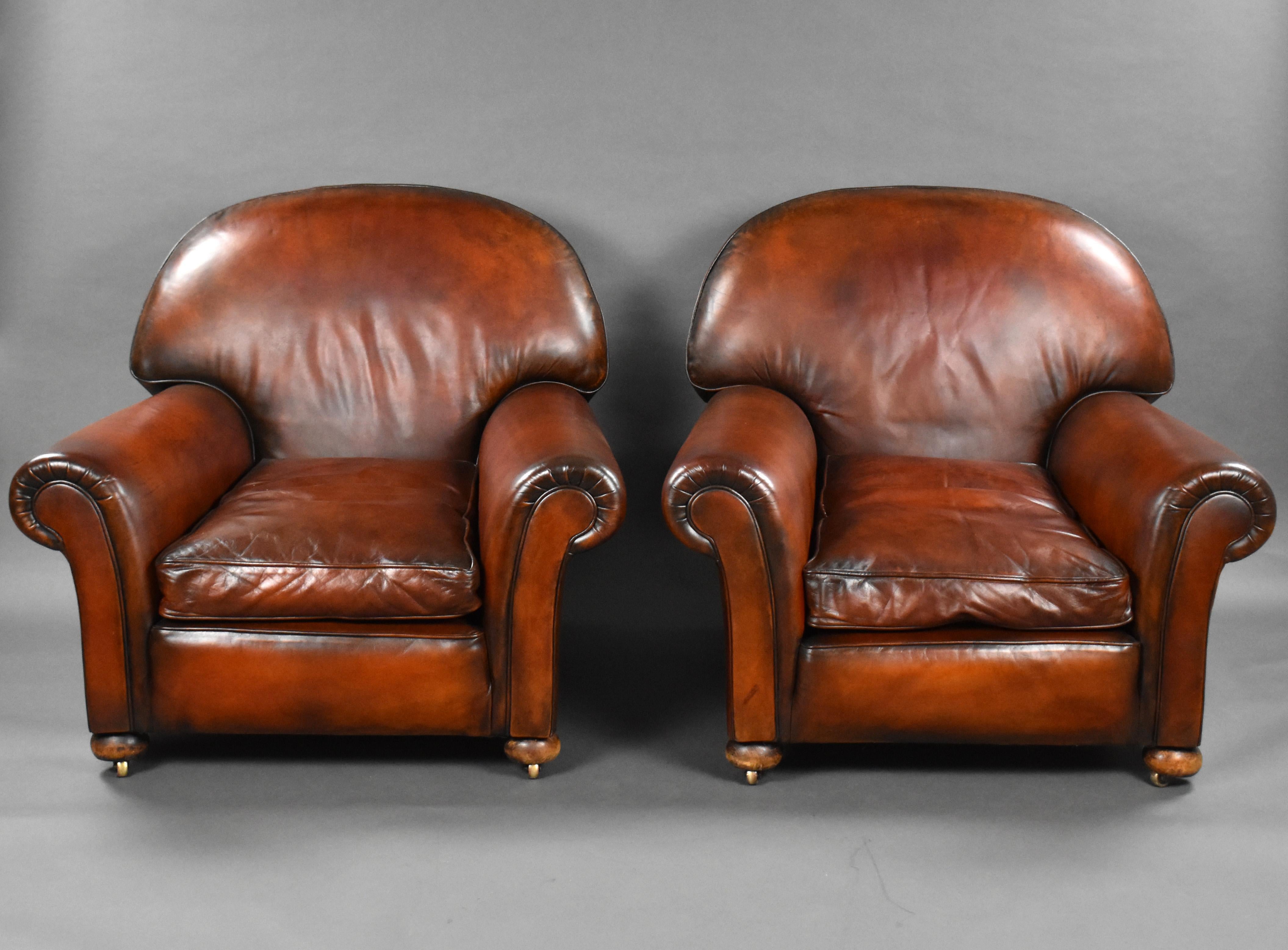 For sale is a good quality pair of large antique hand dyed leather club chairs, with feather stuffed seats, standing on bun feet. Each chair remains in good order. 

Measures: Width: 100cm Depth: 103cm Height: 82cm.