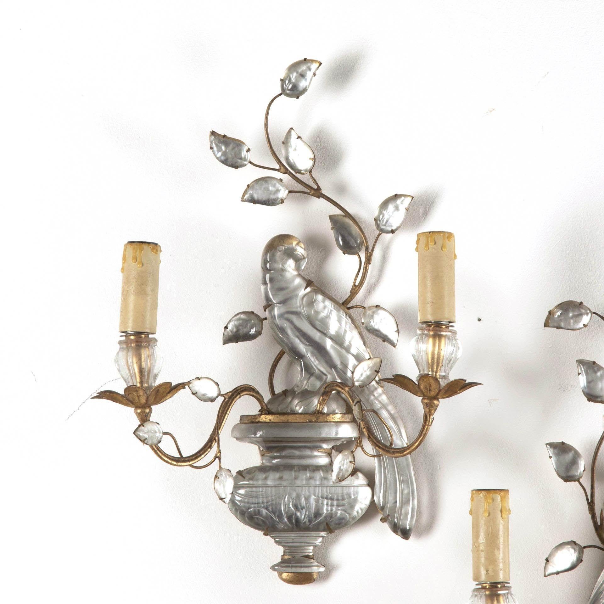 Pair of mid 20th century crystal wall appliques with parrot motif by Maison Bagues, Paris.
Each with two candle brackets and bearing original makers label on reverse.
This item has passed PAT testing according to UK standards.