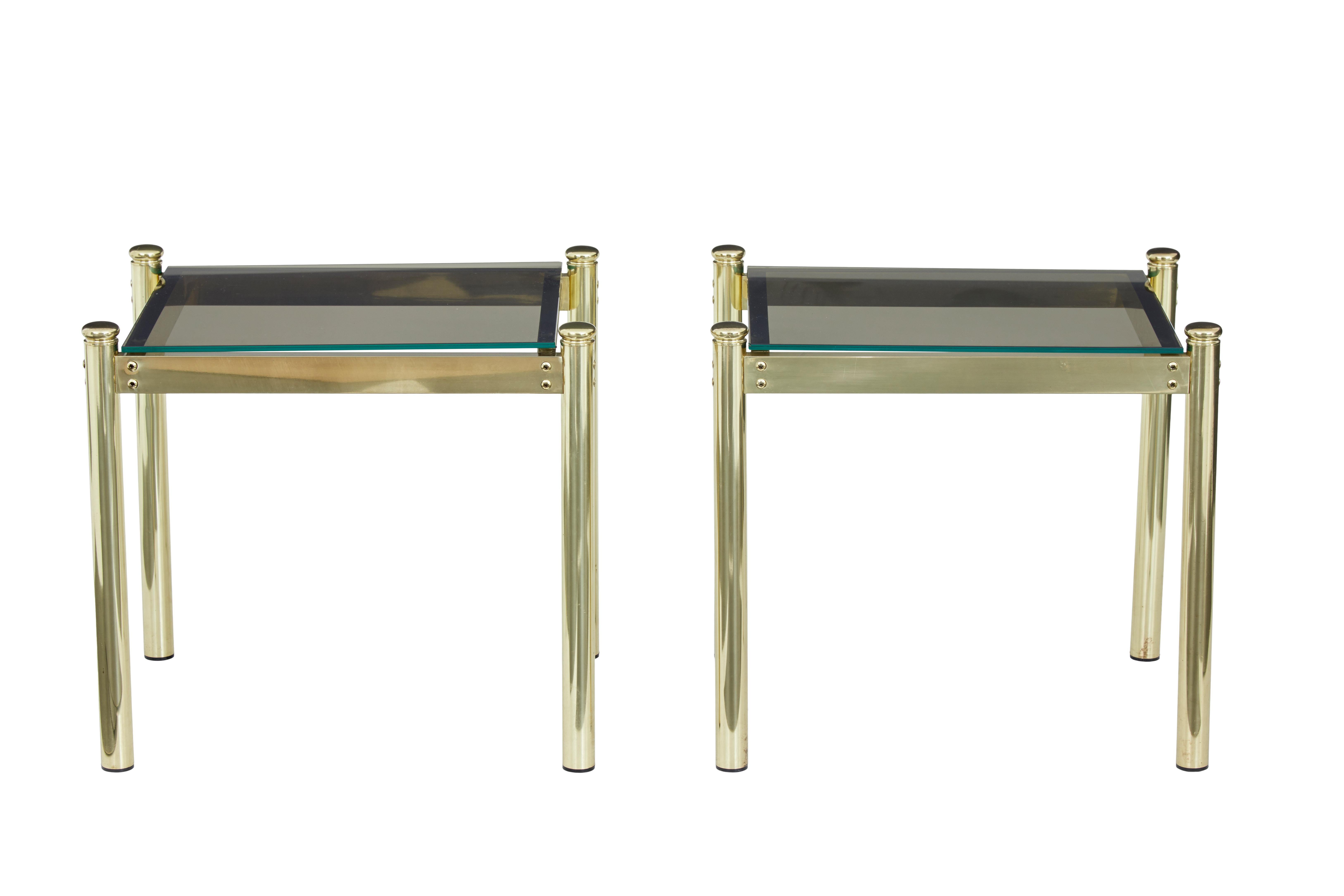 Stylish pair of 1970s brass occasional tables.

Elegant brass frames with round straight legs, inset smoked glass tops.

Good condition, for possible use inside or outside the home.