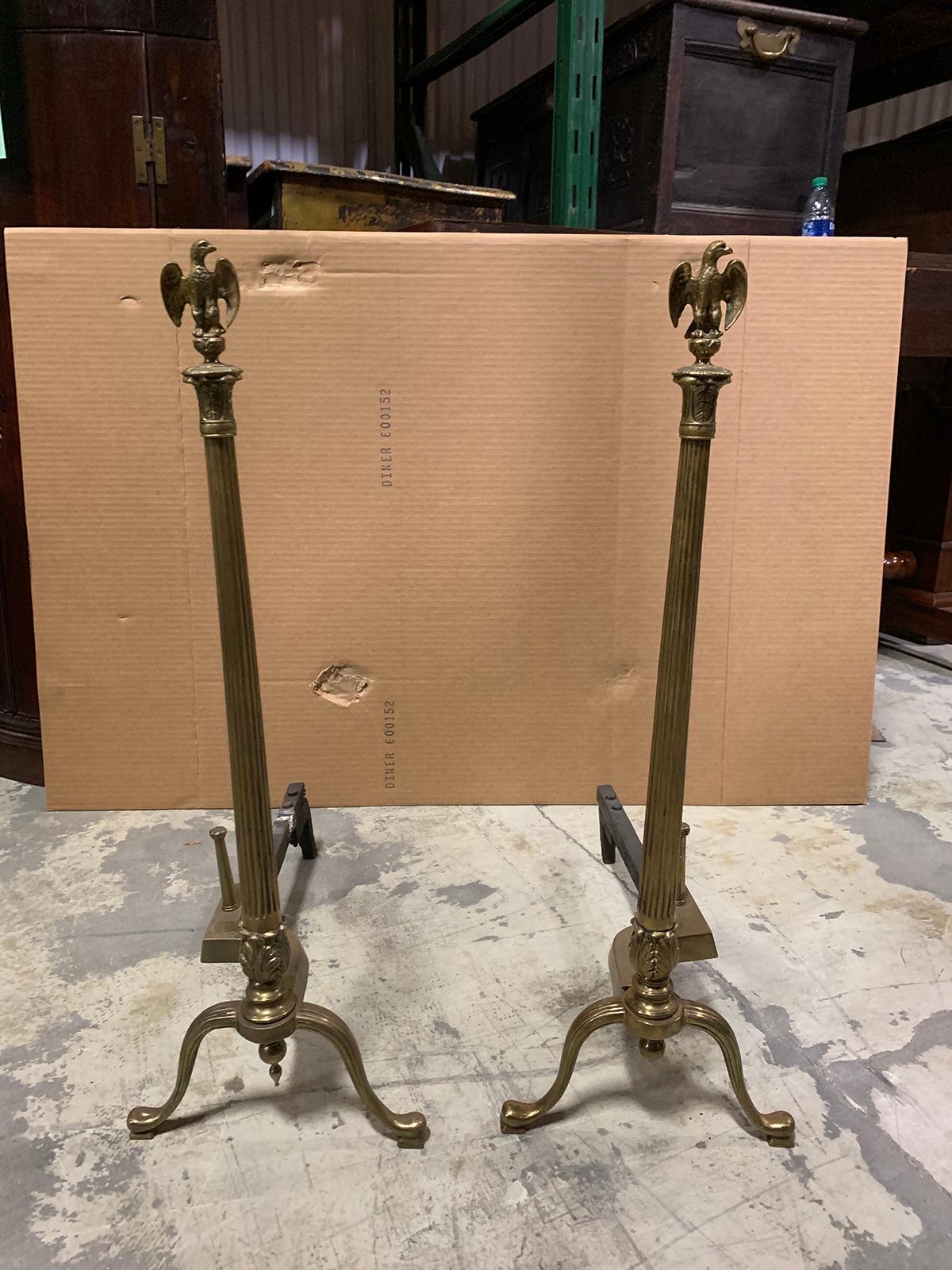 Pair of 20th century brass fluted column andirons with eagle finials.