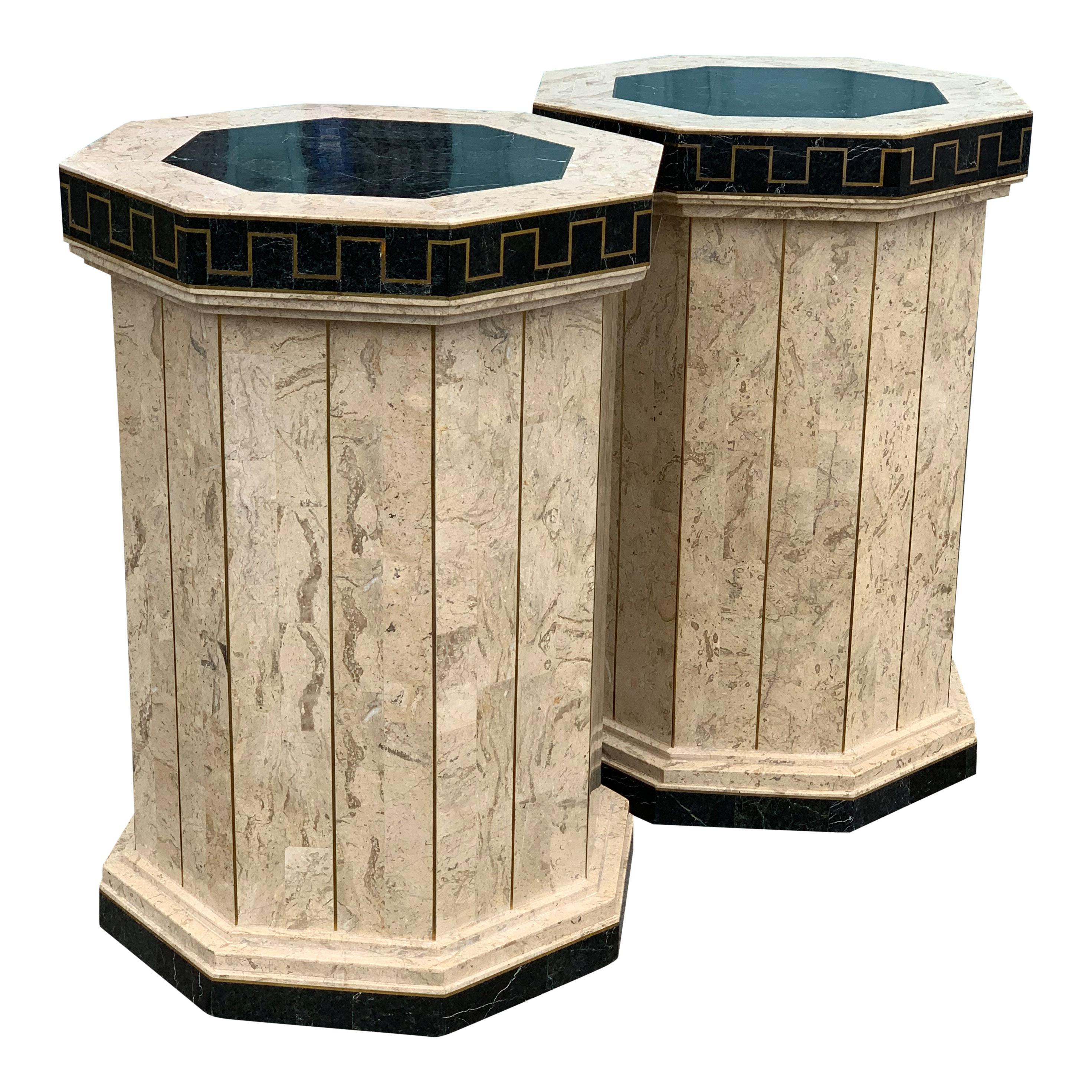 A pair of Hollywood Regency, Maitland and Smith pedestals, veneered Travertine and marble and a thick brass inlay decorated with a Versace Greek key border.

Also have a very similar Maitland and Smith console table in stock.