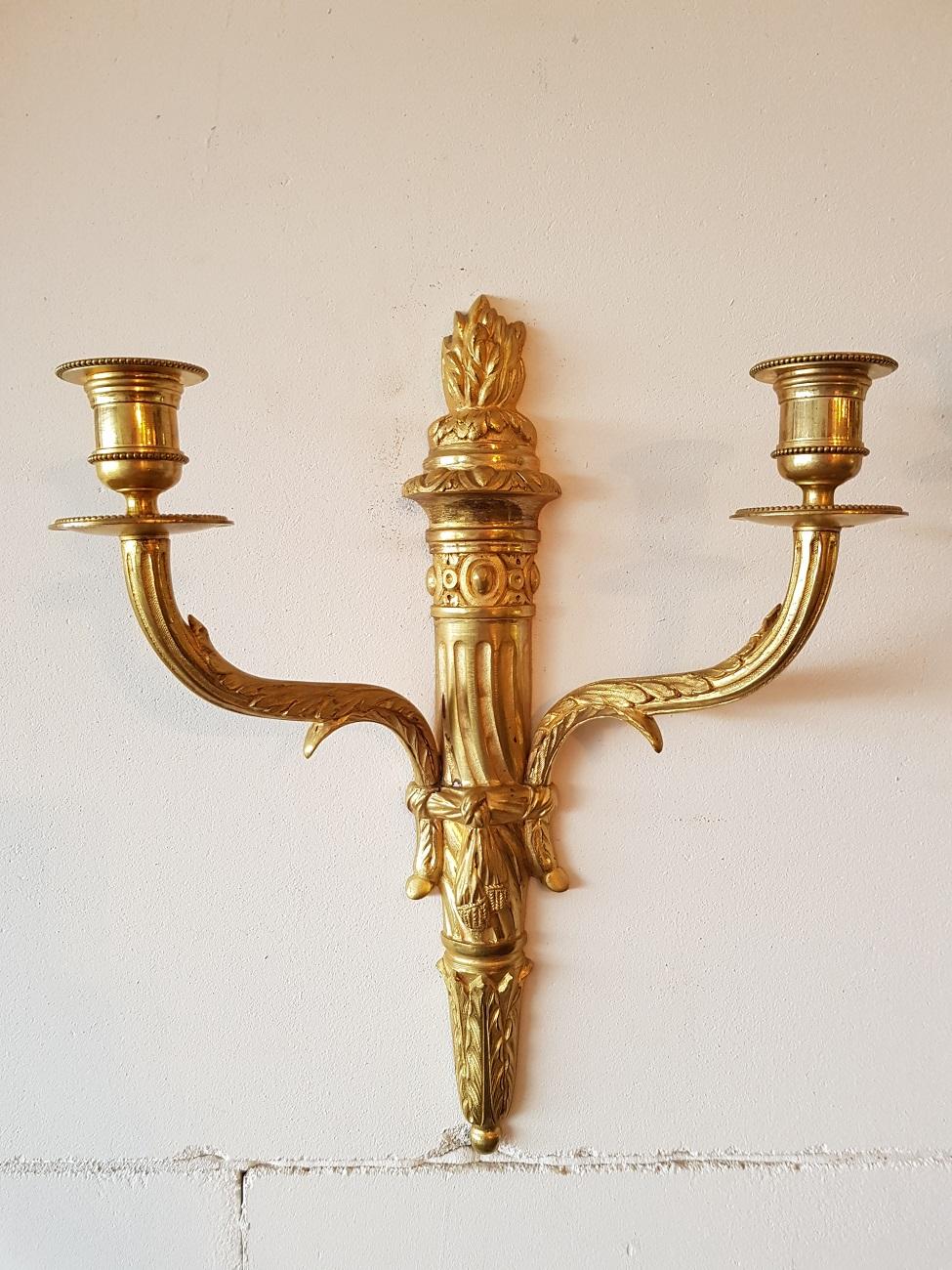 A beautiful pair identical bronze candle sconces in Louis XVI style, both numbered 10302 and the marked with letter F and originates from the 20th century.

The measurements are,
Depth 10.5 cm/ 4.1 inch.
Width 30.5 cm/ 12 inch.
Height 37 cm/