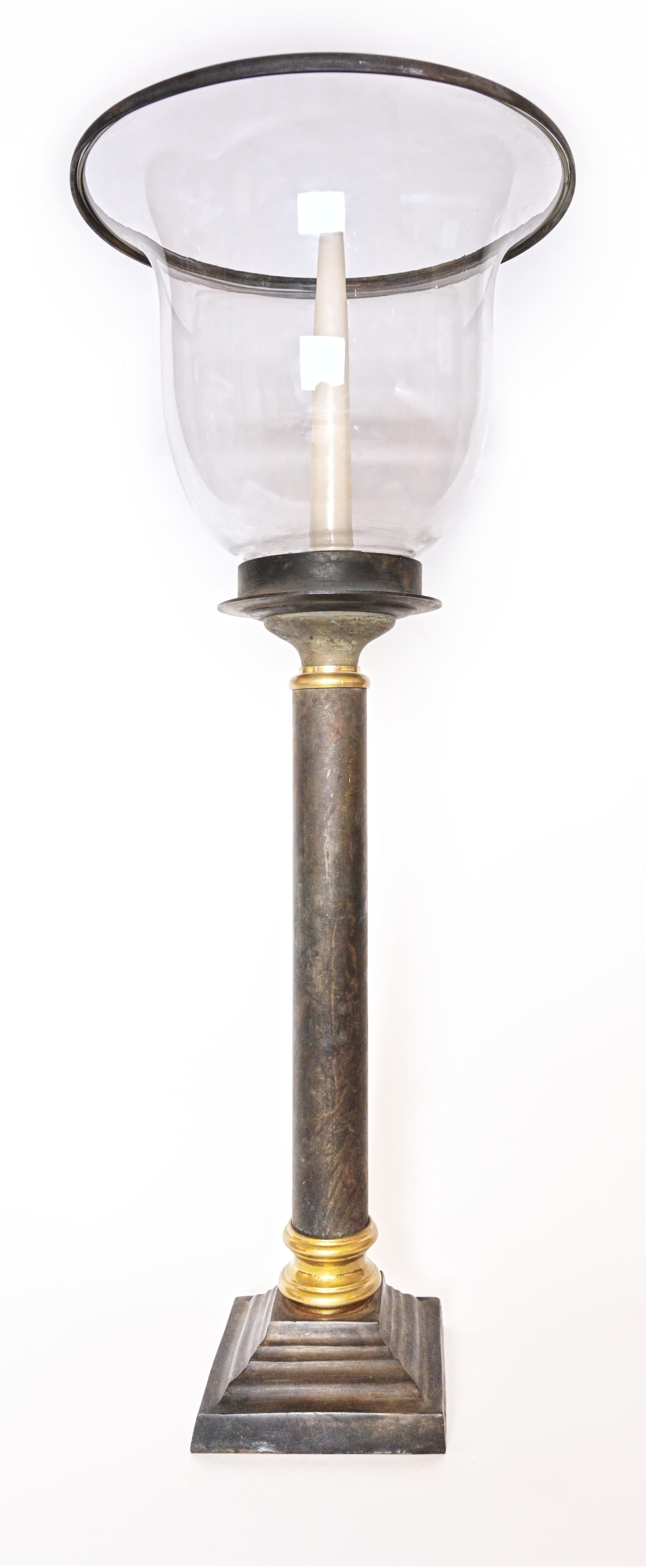  Ein Paar Votivlaternen mit einem umgedrehten Glasschirm, der auf einem bronzenen Säulenstiel ruht, mit Messingakzenten entlang der Oberseite und der Basis. Ca. 1920er Jahre. 
