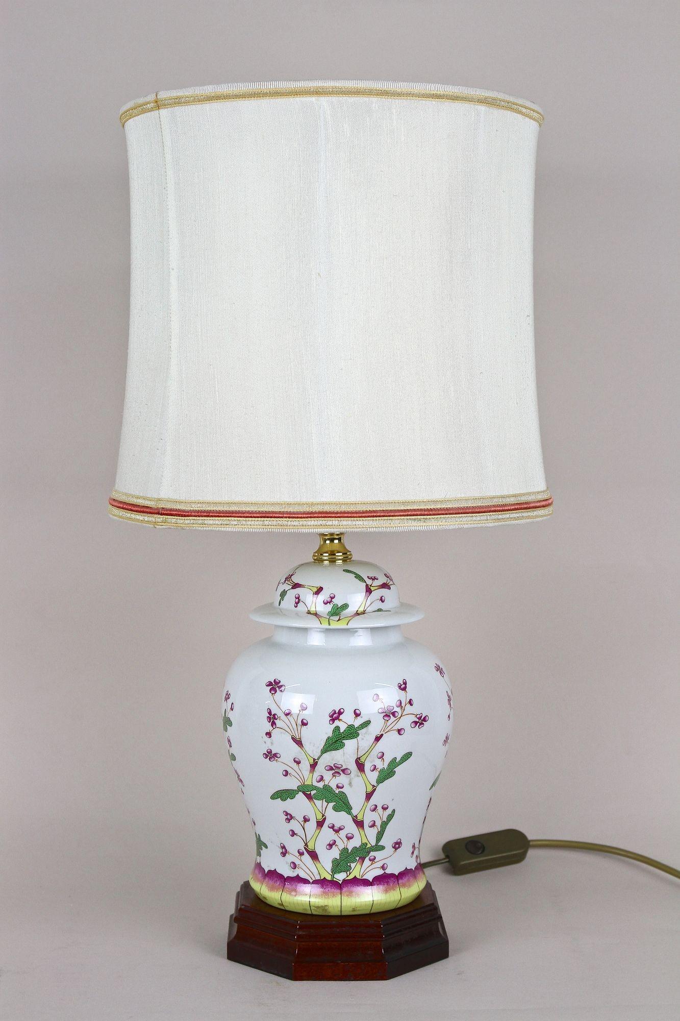 Lovely pair of late mid century modern Italian ceramic table lamps with lampshades from the 1970s. The beautifully designed, bulby white ceramic bodies impress with a unique painted floral/ botanical pattern in purple, yellow and green. Standing on
