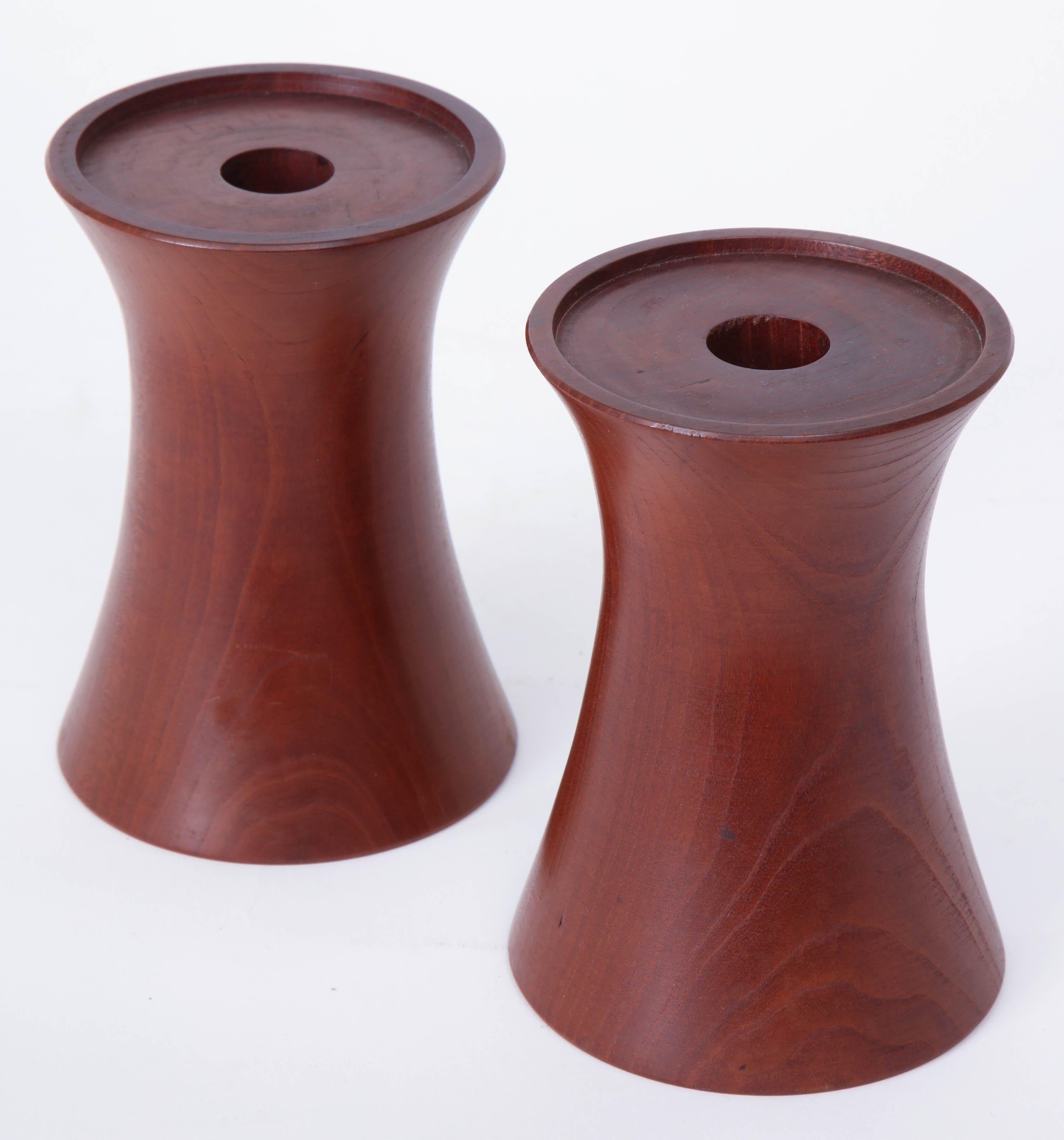 Pair of 20th century cherrywood candleholders, signed 