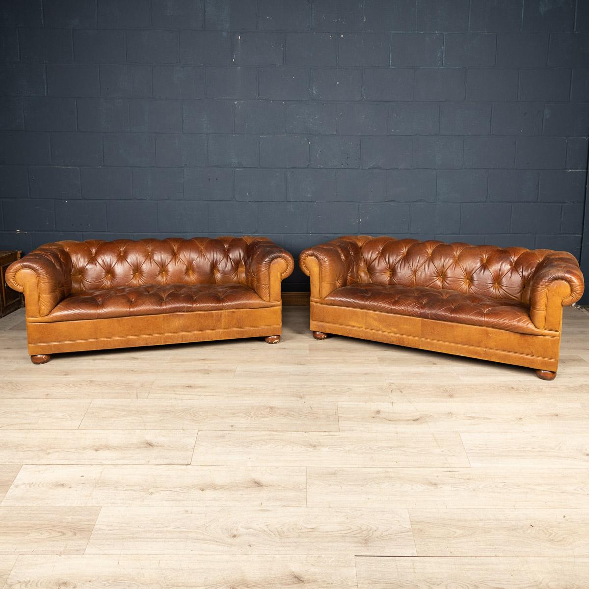 A superb pair of leather Chesterfield sofas retailed by Laura Ashley around the latter part of the 20th century. One of the most elegant models with button down seating, this is a fashionable item of furniture capable of uplifting the interior space