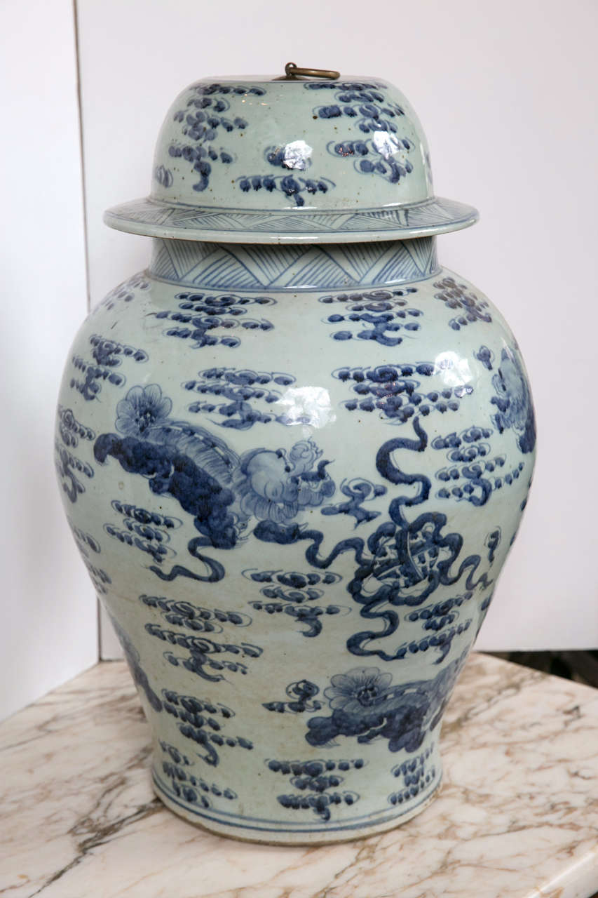 Porcelain baluster shaped jars with metal ring topped lids. Decorated with clouds, dragons, ribbons and cross hatching.