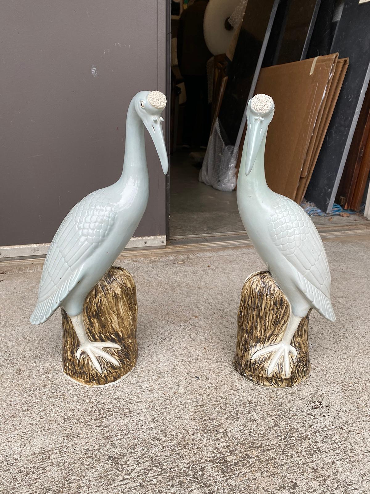 Large scale pair of 20th century Chinese celadon porcelain cranes on craggy rocks.