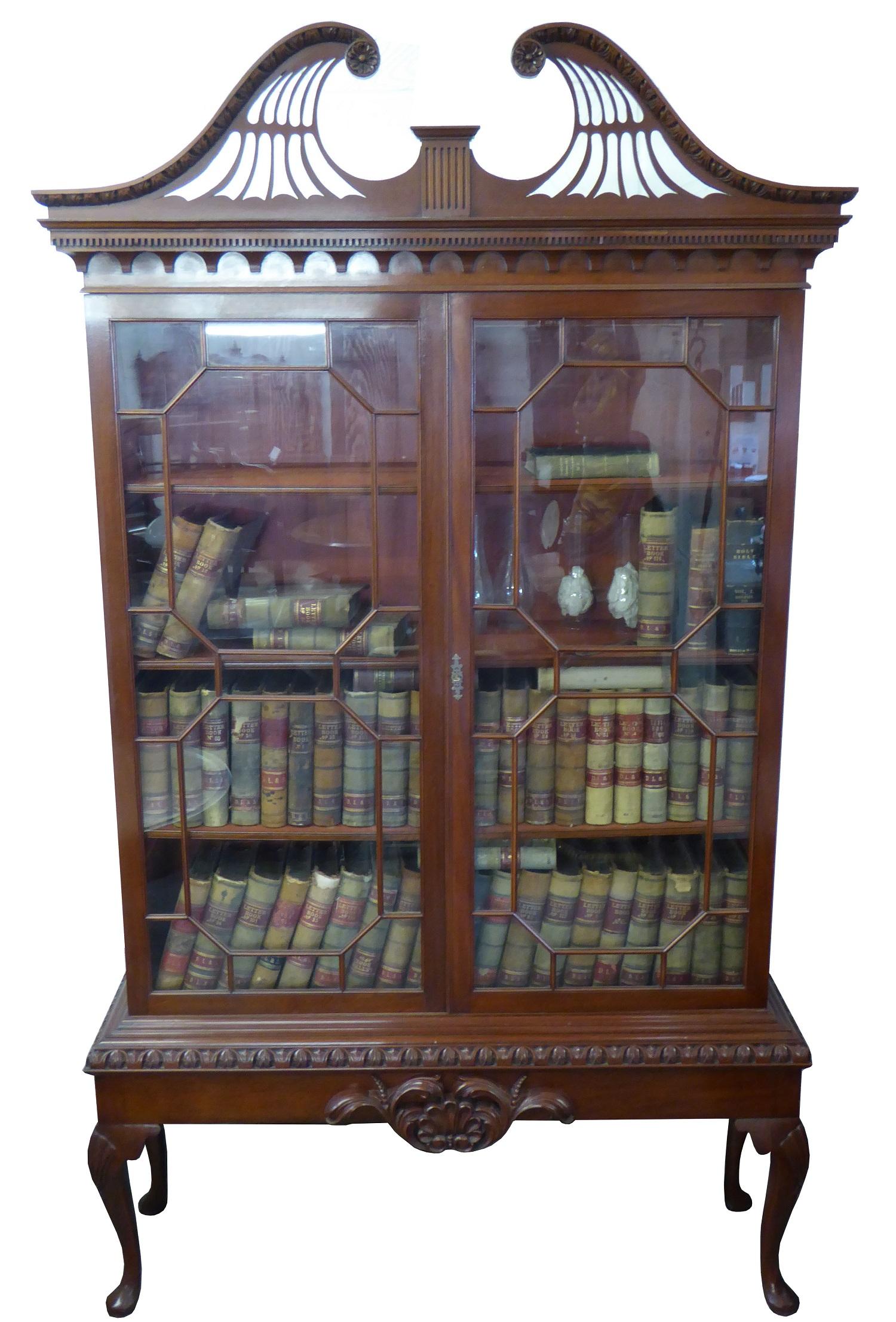 For sale is a fine quality matching pair of Chippendale Revival bookcase. Each bookcase has an ornate swan neck pediment with egg and dart molding above dentil molding, with two astregal glazed doors enclosing adjustable shelves. The bookcases both