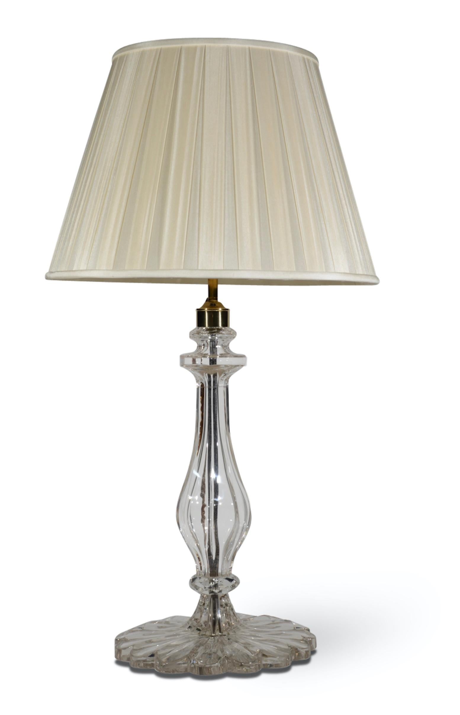 A superb pair of clear cut glass table lamps, each with moulded faceted baluster stems, and scalloped base.

Height: 19 in (48.5 cm) excluding electrical fitments and lampshades.

All of our lamps can be wired for use worldwide. A selection of card,