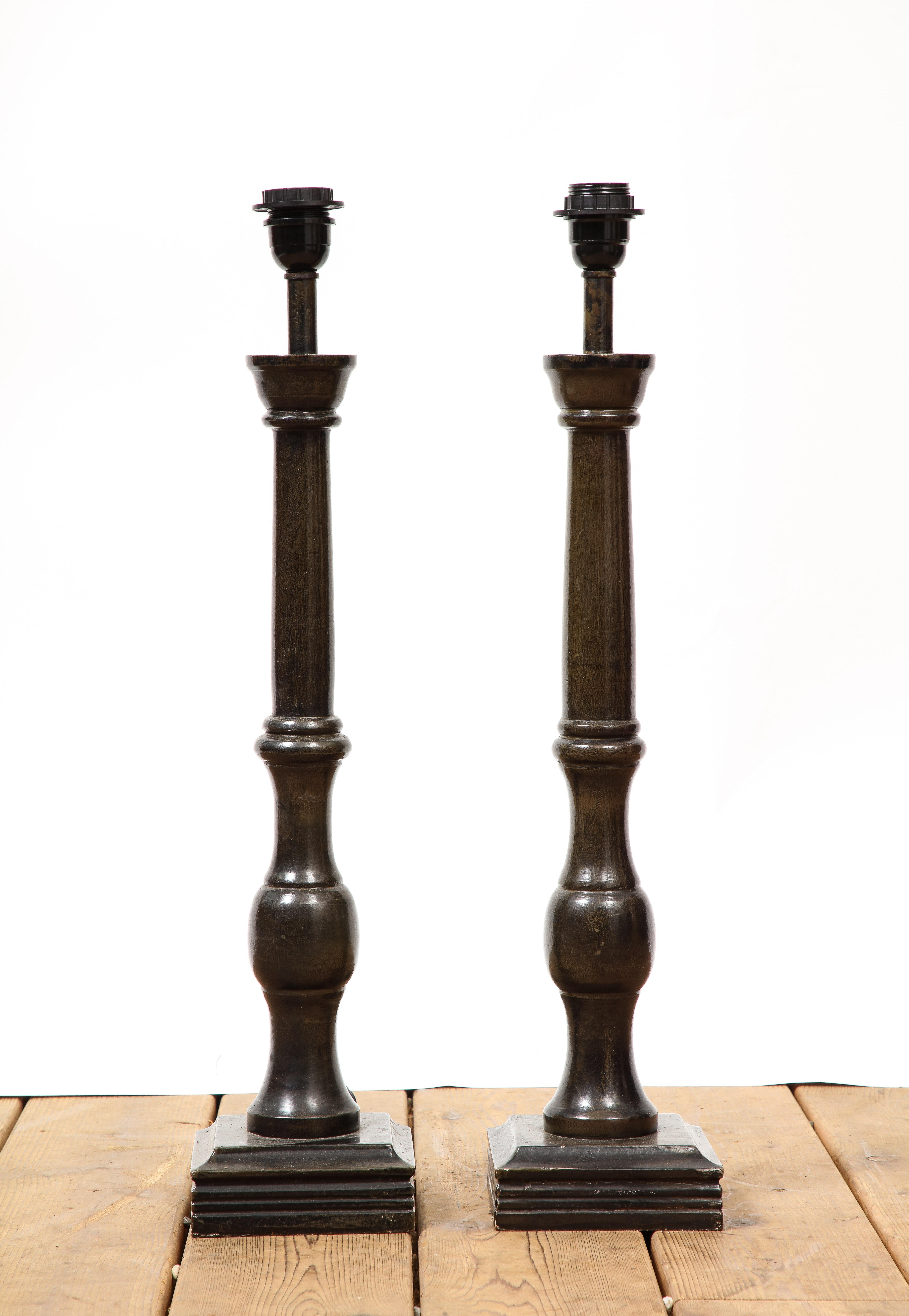 Pair of 20th century Continental turned wood tall table lamps. 1 socket per lamp. 