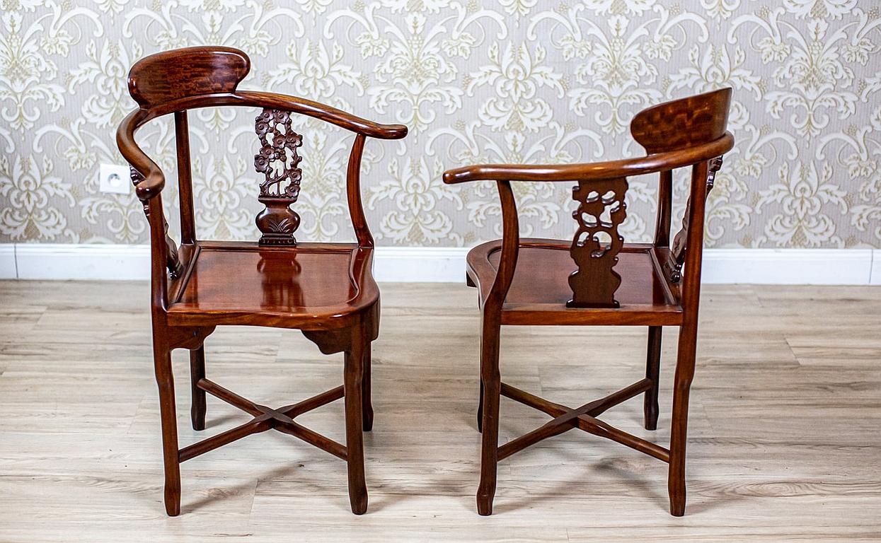 Pair of 20th-Century Exotic Wood Corner Chairs in Varnish

We present you a pair of corner chairs, circa after 1945, made in exotic wood.
The semi-round backrests turn into armrests, which are rolled outwards.
The simple form of the furniture is