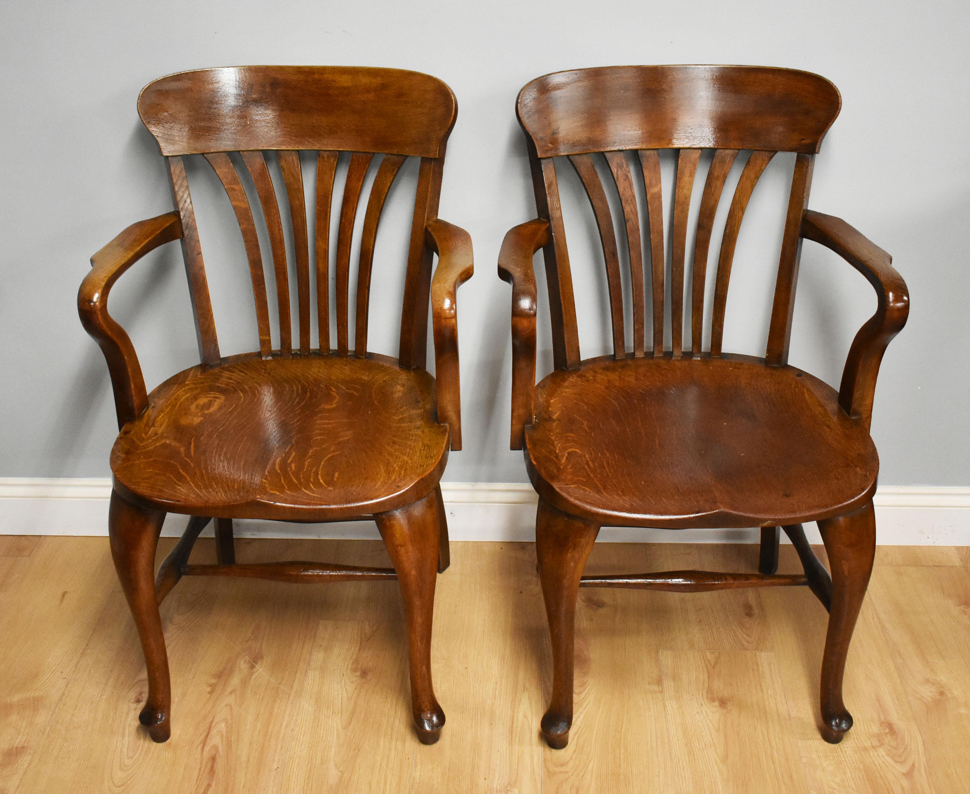 For sale is a good quality pair of solid oak Edwardian desk chairs by T. Oliver, Torquay. Both of the chairs are in very good original condition, being structurally sound and showing no signs of old repairs. 

Dimensions
Width: 22