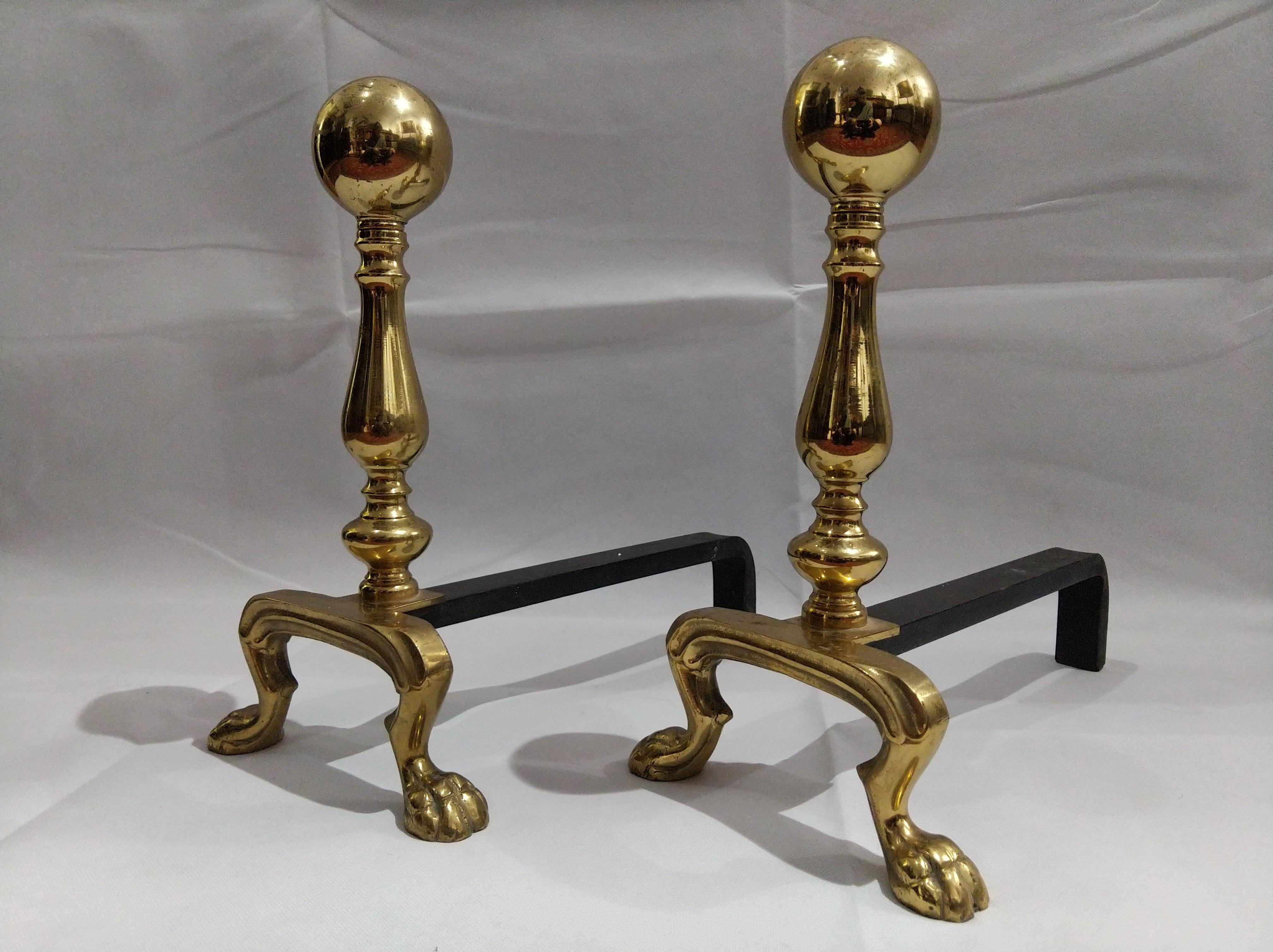 Pair of Early 19th century Empire polished brass and iron andirons with lion's feet.

The Empire style is an early-nineteenth-century design movement in architecture, furniture, other decorative arts, and the visual arts, representing the second