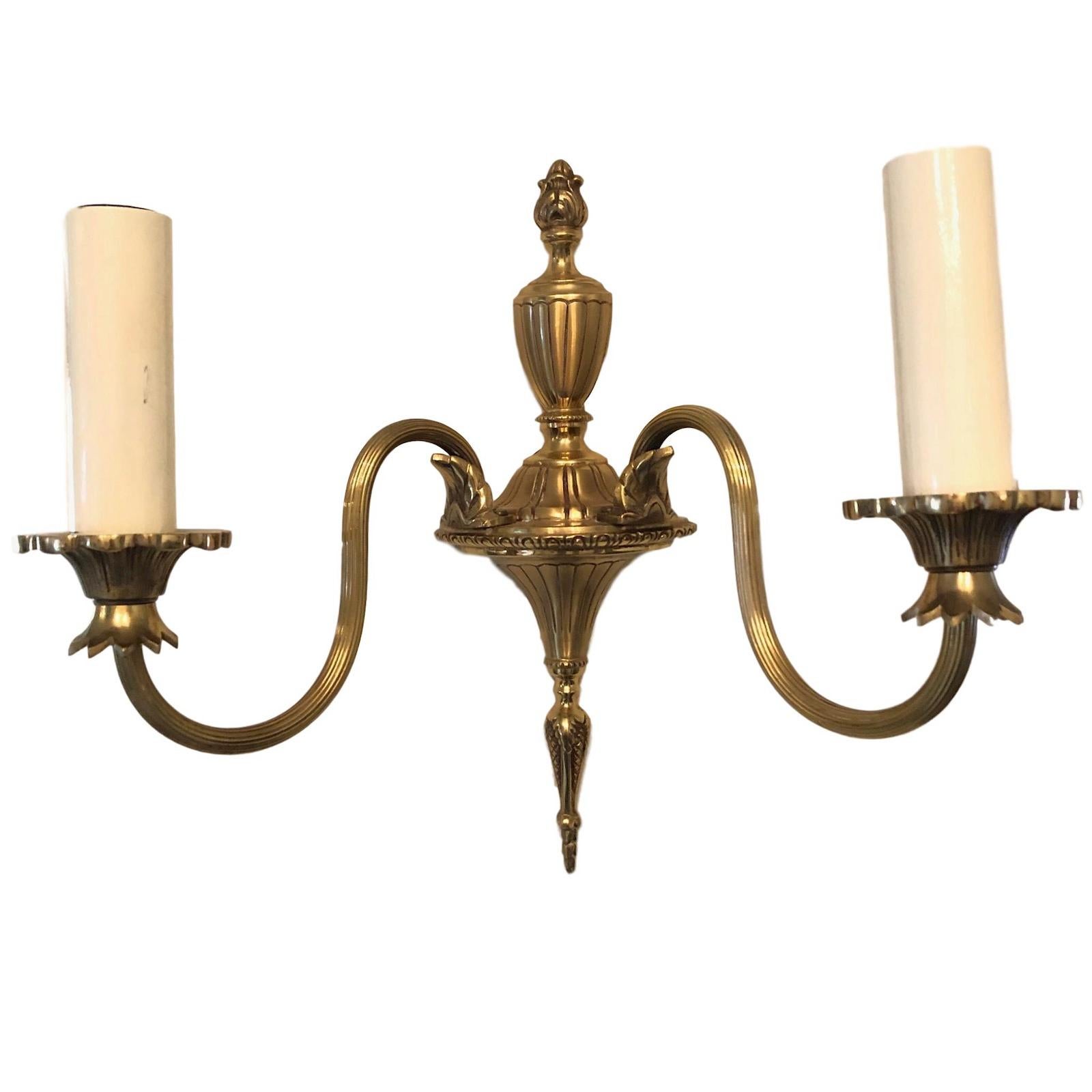 A stunning pair of heavy bronze wall sconces. Each consisting of a stylish Empire style design. Each fixture requires two European E14 / 110 Volt candelabra bulbs, each bulb up to 40 watts.