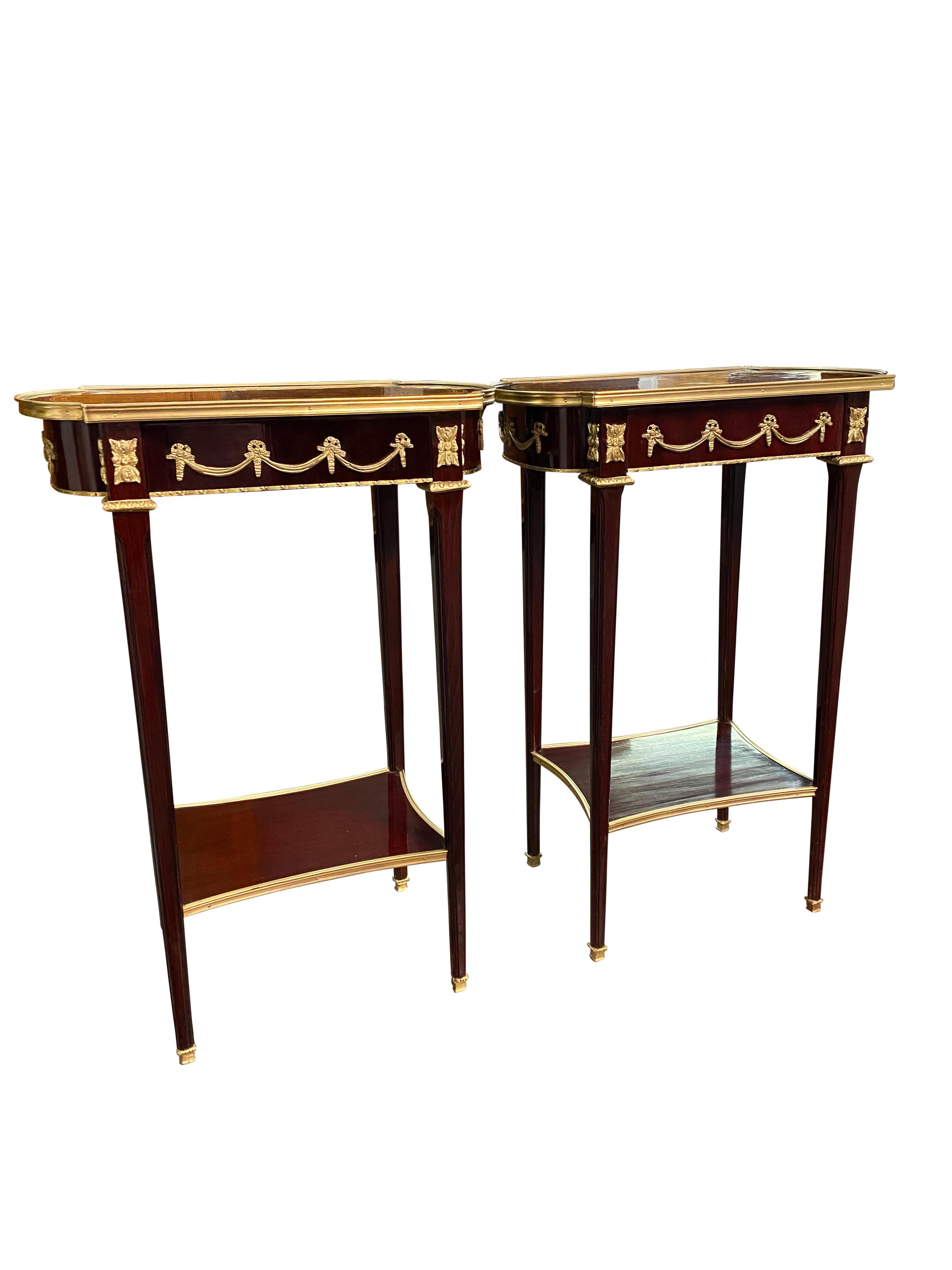 A stunning Pair of 20th century Empire style side tables. A gorgeous and elegant design perfect for modern interiors.