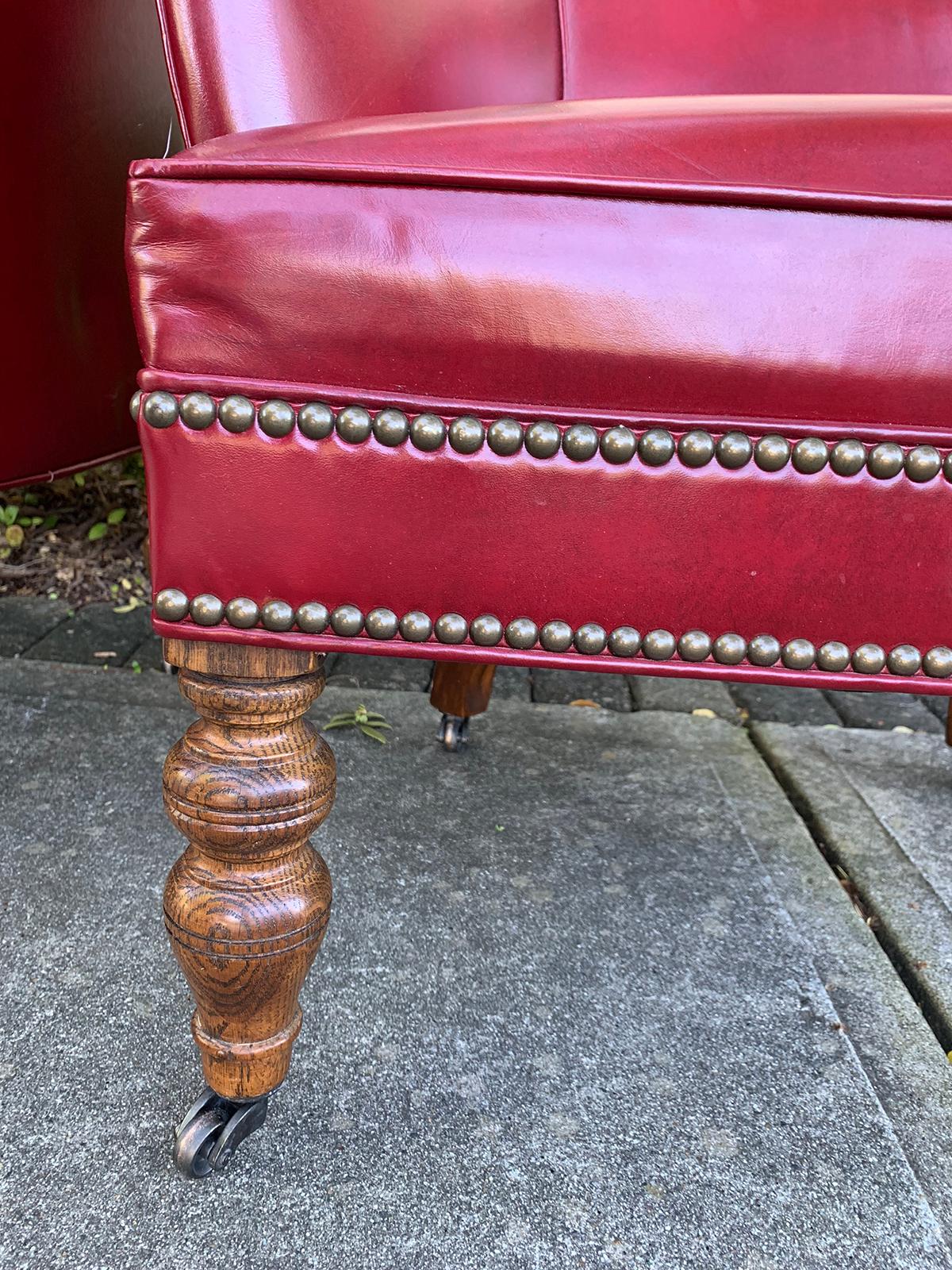 Pair of 20th century English red leather barrel chairs.