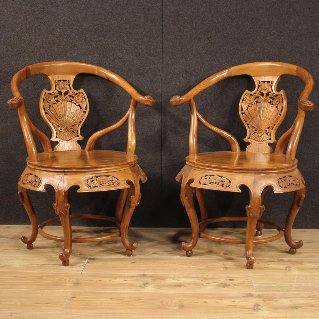 Pair of Chinese armchairs from 20th century. Furniture carved and chiseled in light exotic wood of beautiful line and pleasant decor. Armchairs of discrete comfort ideal to combine with a pillow (not included in the offer). Furniture that can be