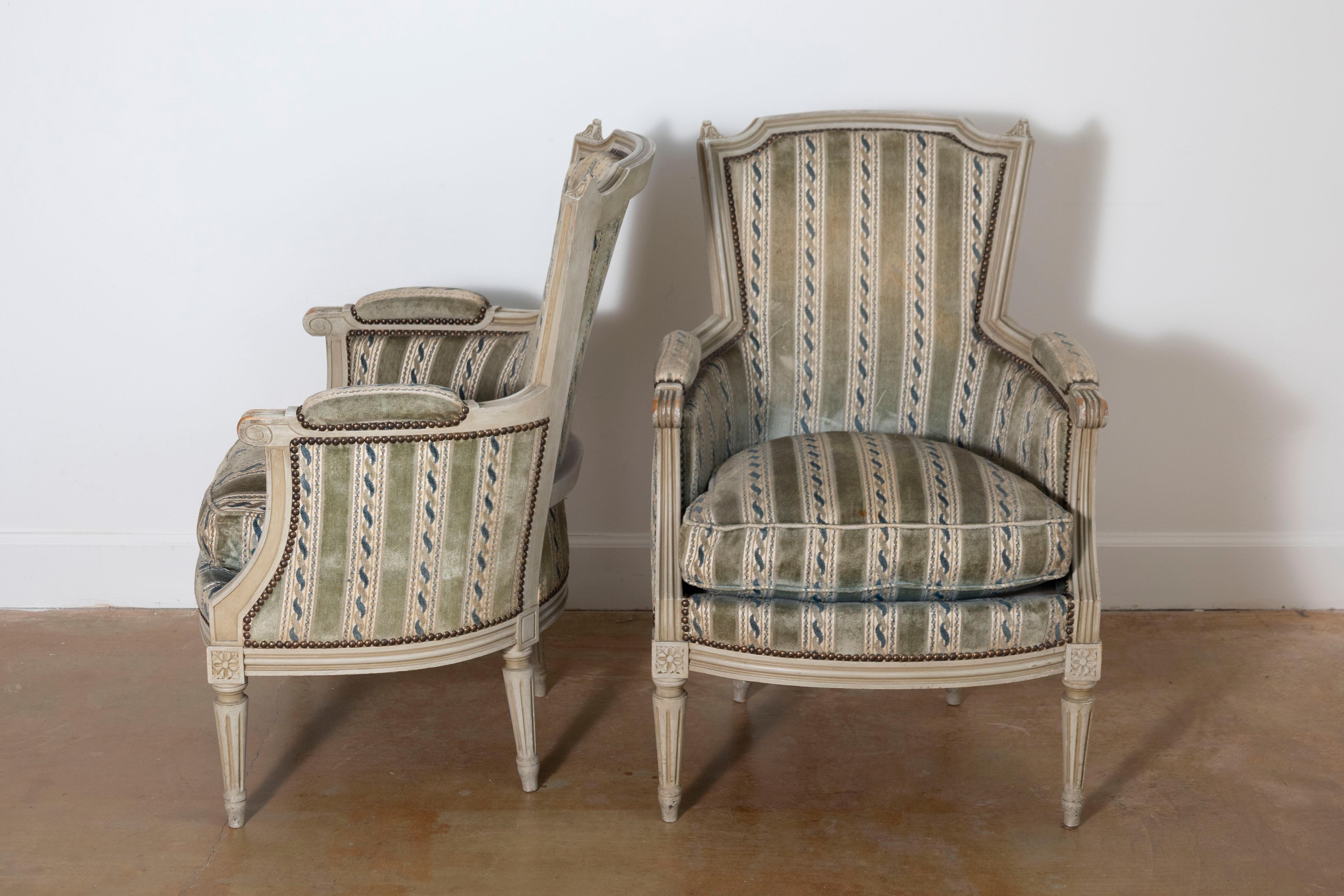 This exquisite pair of 20th-century French bergères combines timeless elegance with comfort, reflecting the sophistication of traditional French design. Crafted in the classic Louis XVI style, these armchairs feature carved beech wood frames, known