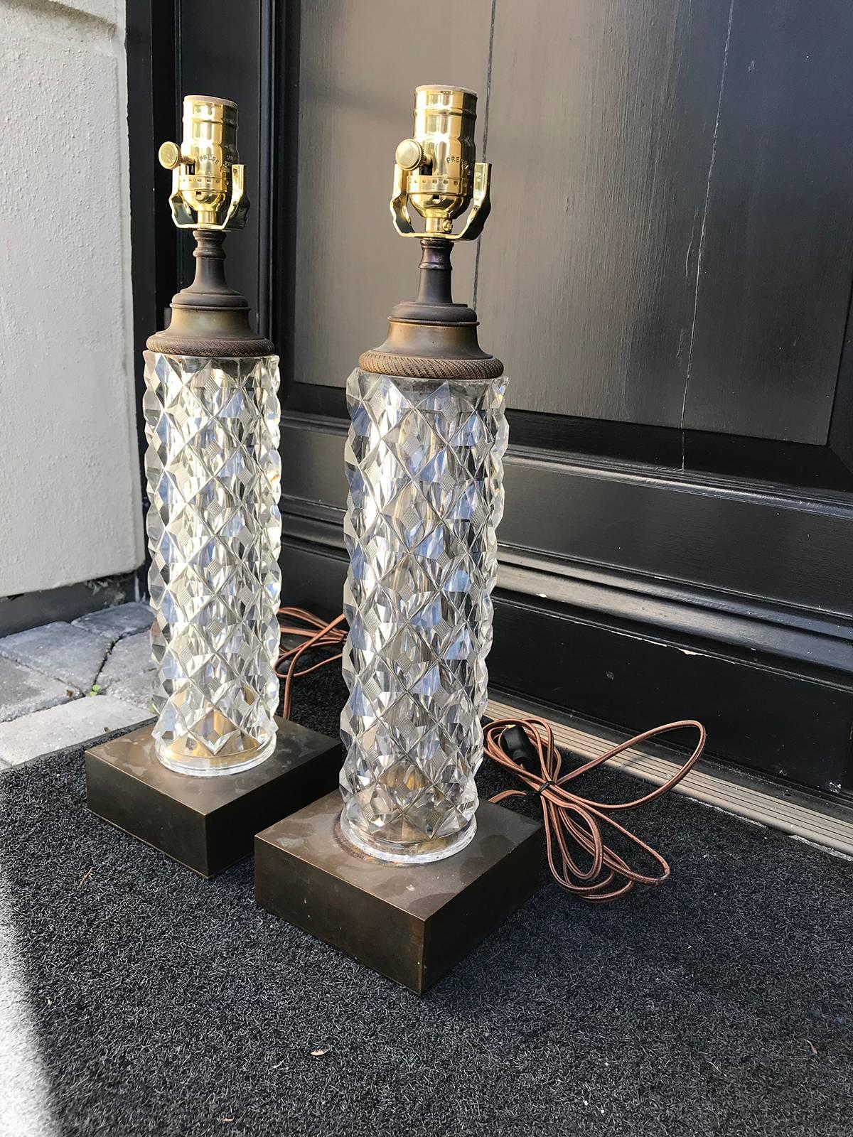 Pair of 20th century French cut and faceted crystal table lamps, bronze bases.