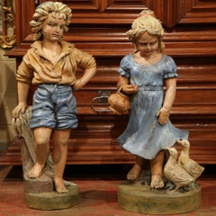 Pair of 20th Century French Hand Painted Iron Boy and Girl Sculptures