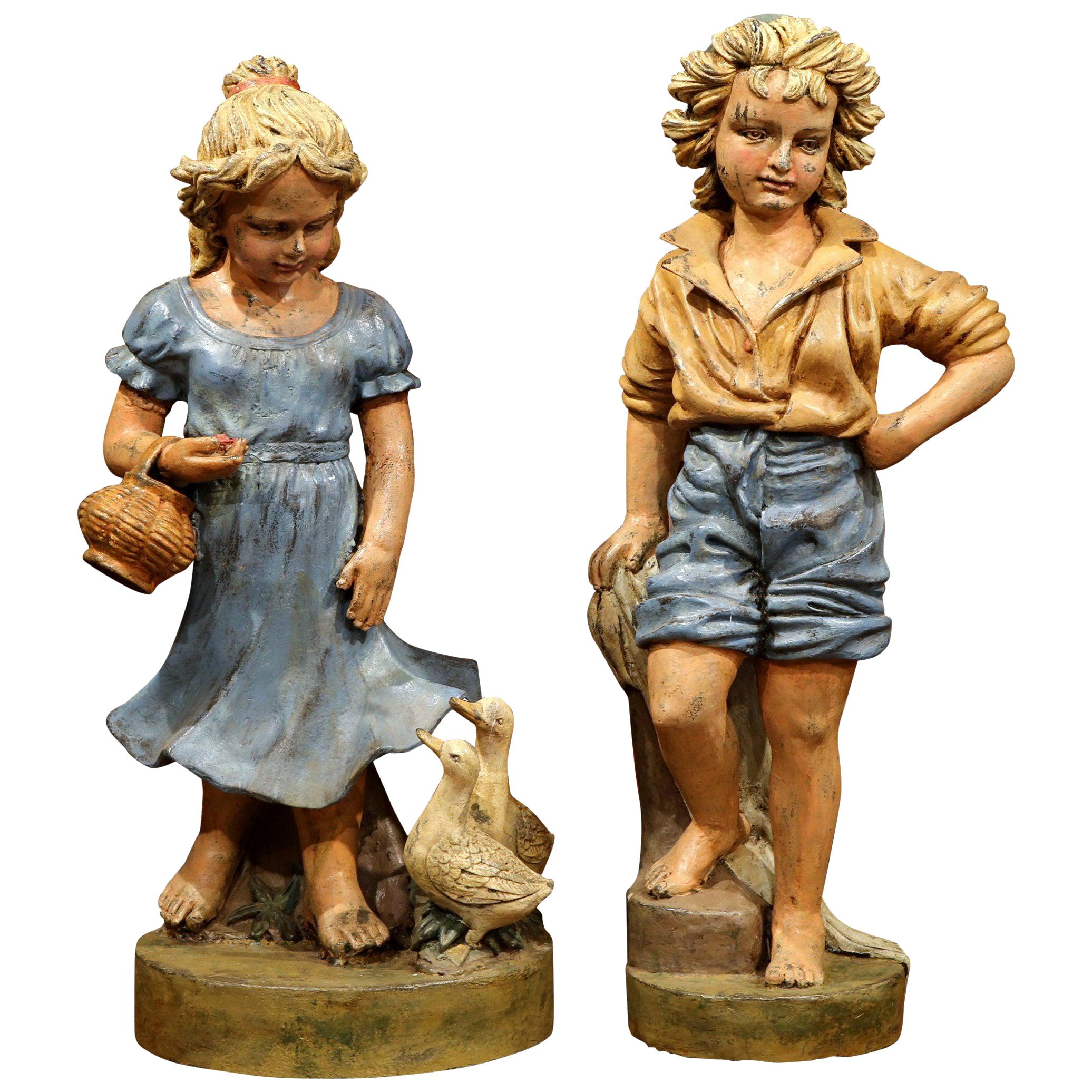 Pair of 20th Century French Hand Painted Iron Boy and Girl Sculptures