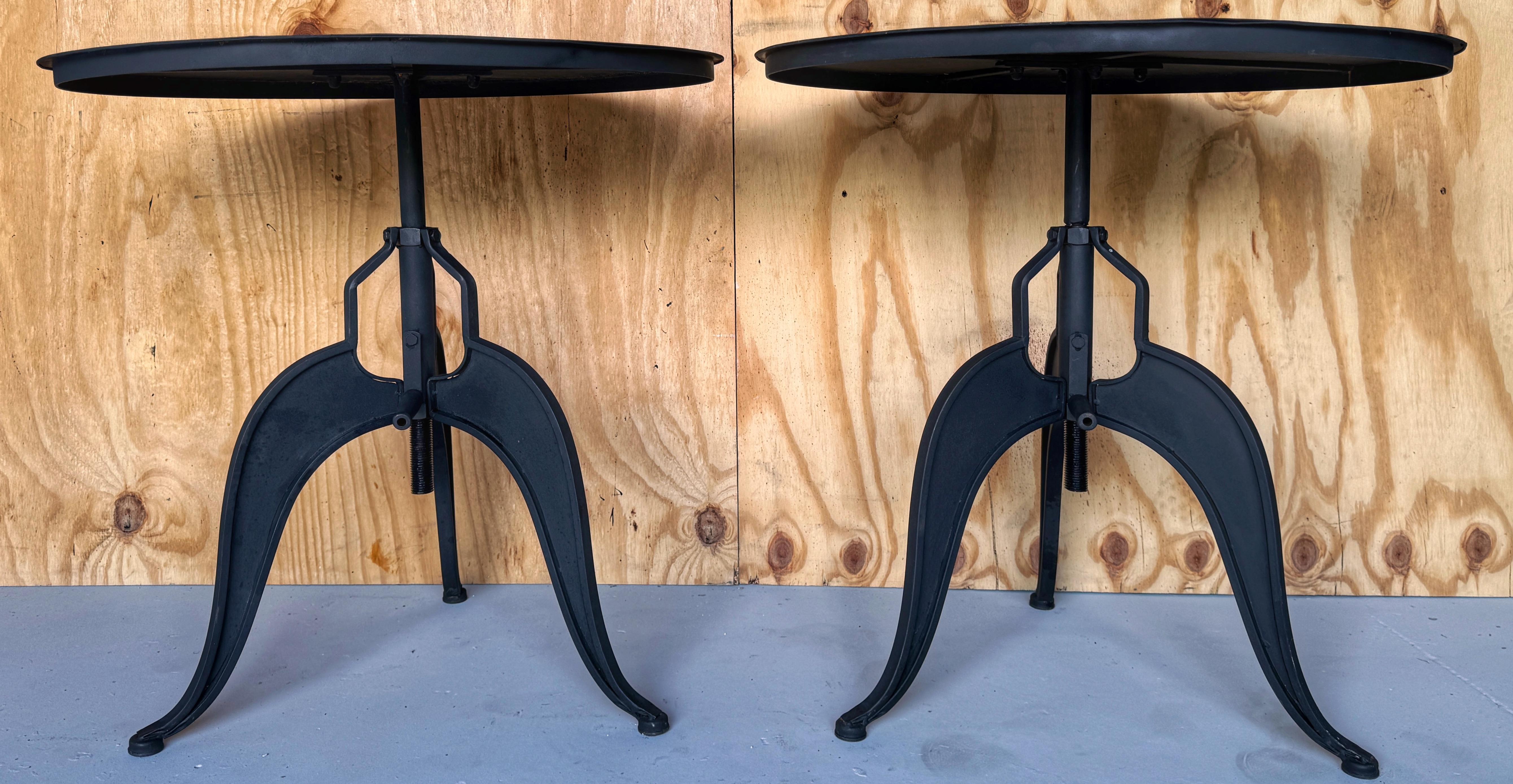 Pair of 20th Century French Industrial Style Adjustable Round Guéridons

Each one with 29.75- inch diameter top with rim, resting on a center column industrial hand -crank adjusting mechanism, with a maximum sturdy height of 40-Inches high that