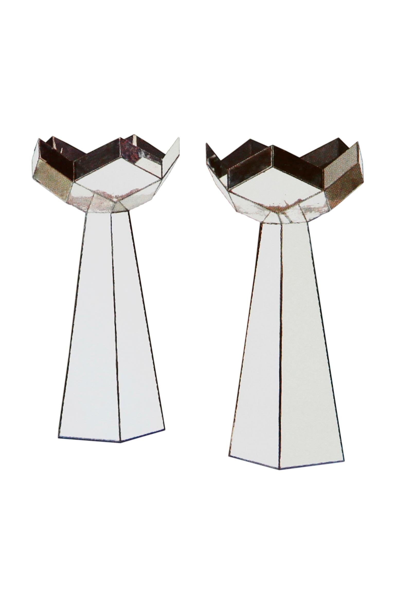 A pair of early 20th century French mirrored ornaments or bases. The five-panel column above a facetted pentagonal base.