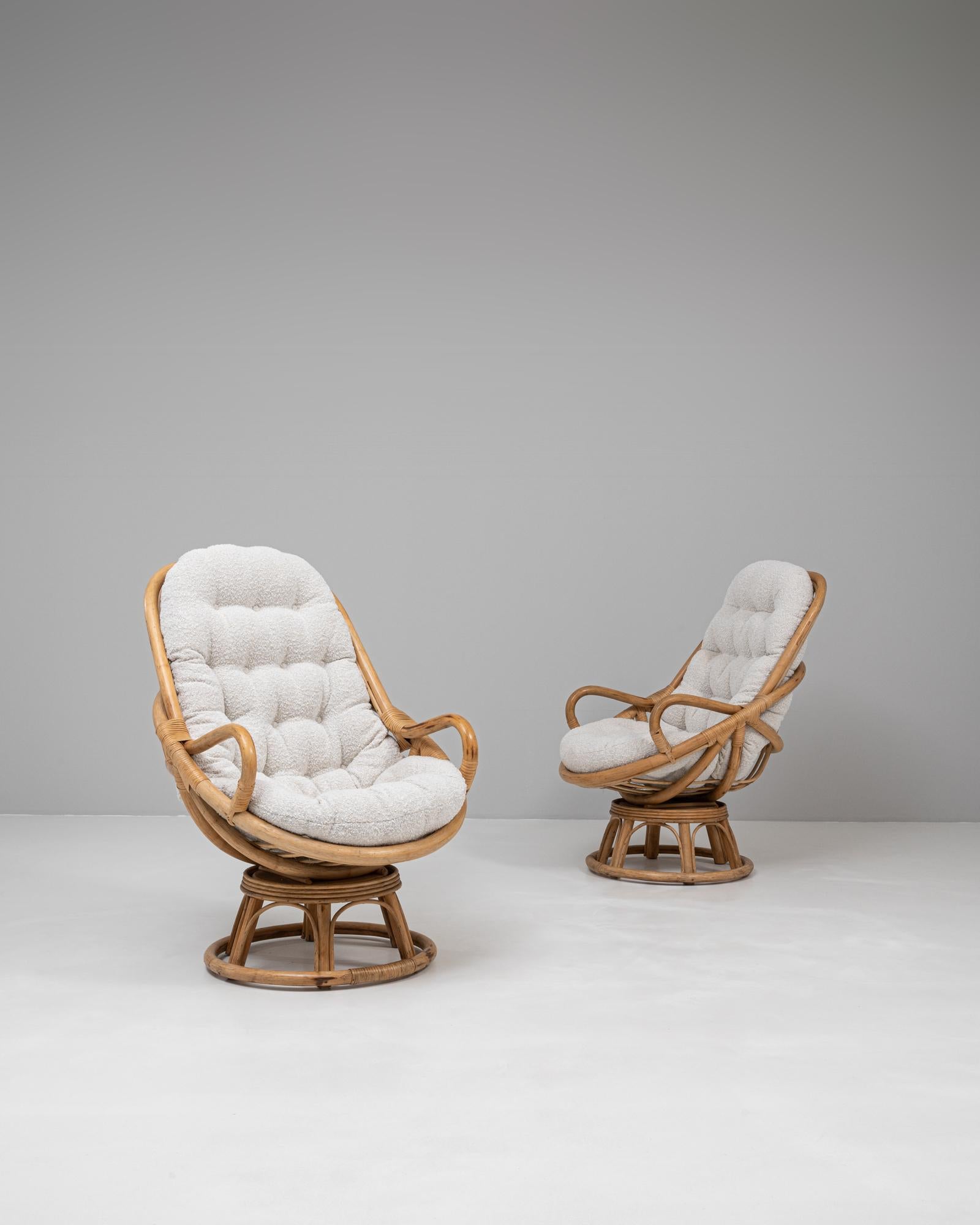 Cette paire de fauteuils pivotants en bambou rembourré allie confort et savoir-faire dans un design qui incarne la sophistication décontractée. Chaque chaise présente une structure sculpturale en bambou avec une finition naturelle chaleureuse, se