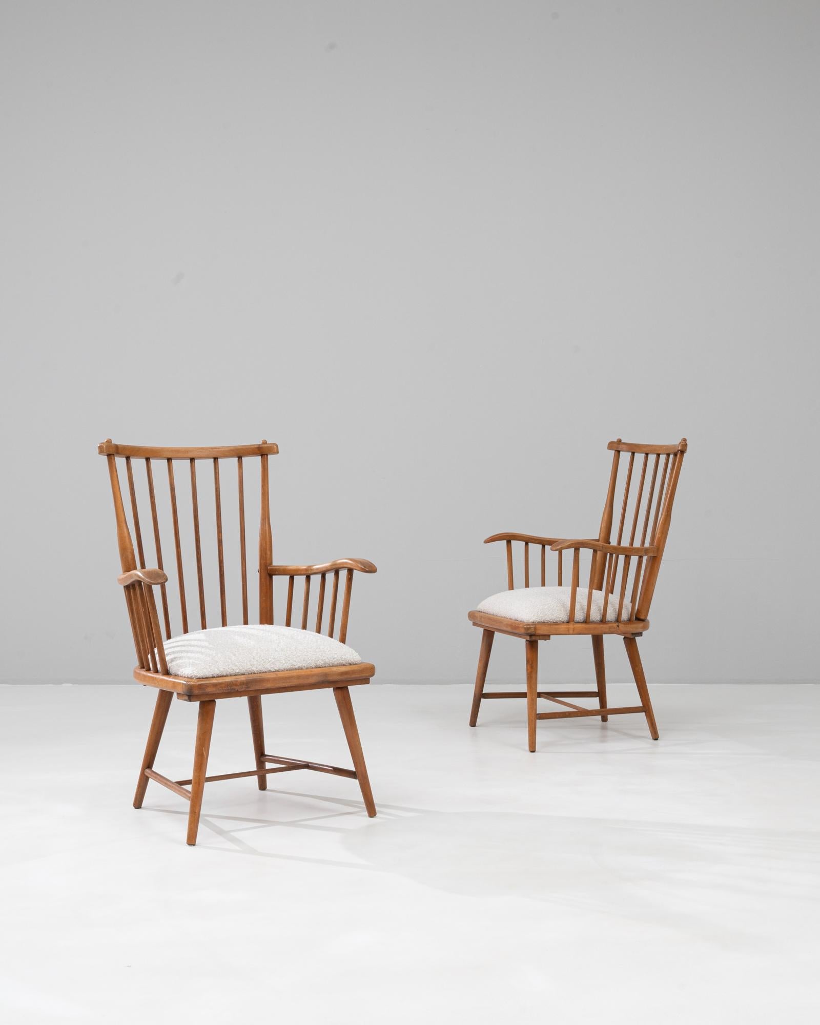 Cette paire de chaises longues en bois françaises du 20e siècle présente une silhouette raffinée et décontractée, mêlant des lignes épurées à un charme rustique subtil. Chaque chaise est fabriquée à partir de bois aux tons chauds et conçue avec un