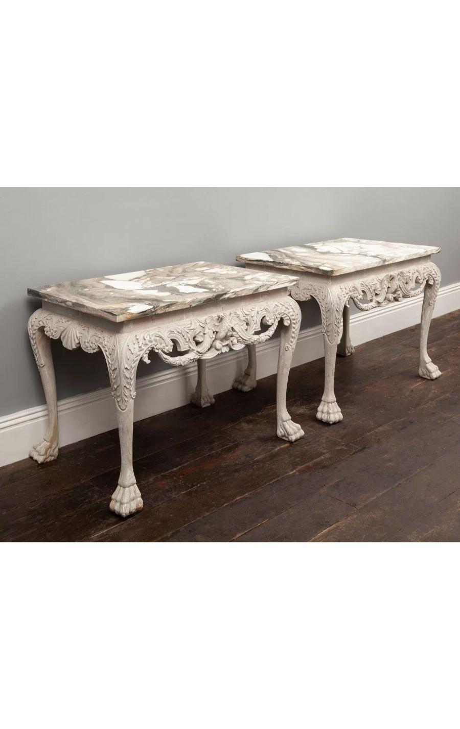 A pair of George II style painted wooden console tables with Italian Breccia marble tops.

The well carved foliate frieze with an eagle at the centre. The cabriole legs with lion paw feet.

20th century 

Additional