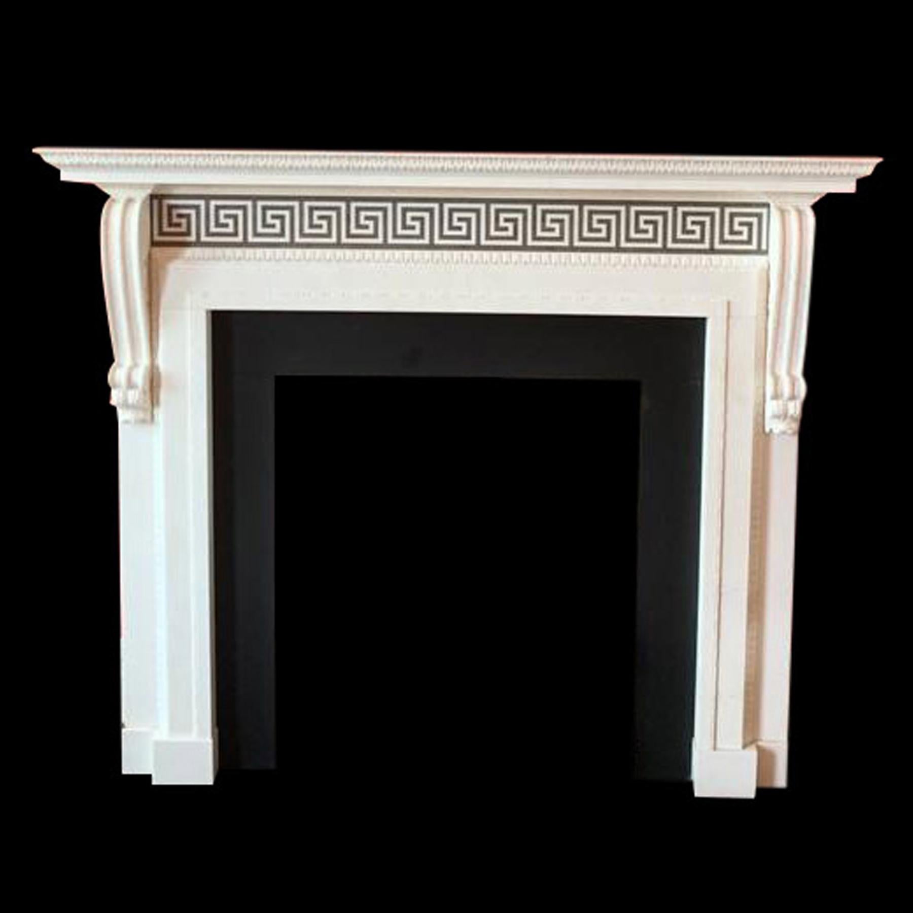 Very happy to offer this handsome pair of Georgian Style Chimneypieces.

Carved Corniced Shelf above a runnng frieze with a Greek key Azul Valverde inlay and jambs that terminate in delicately carved console.

Fireplaces are priced seperately and
