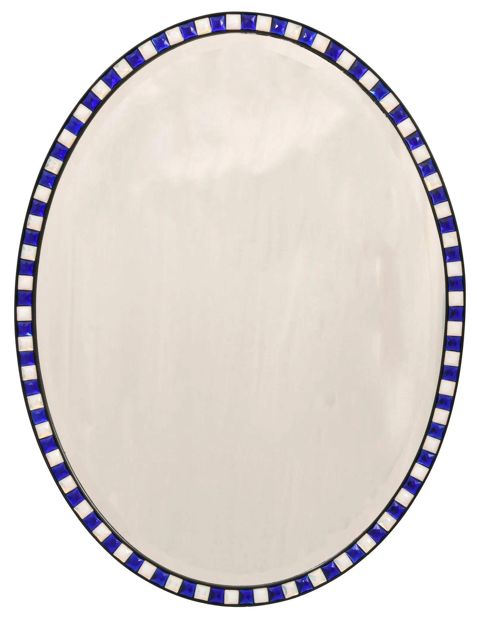A 20th century Oval Mirror having bordered alternating blue and white glass panels with applied gilding in the traditional 18th century manner. Circa 1920s.