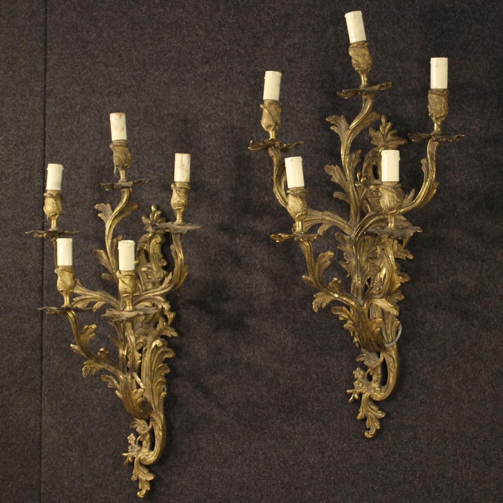 Pair of 5-light French wall lights from the early 20th century. Gilded and chiseled bronze objects in beautiful patina of great size and impact. Electrical system to be restored (see photo). Finely chiseled appliqués with Louis XV style decorations,